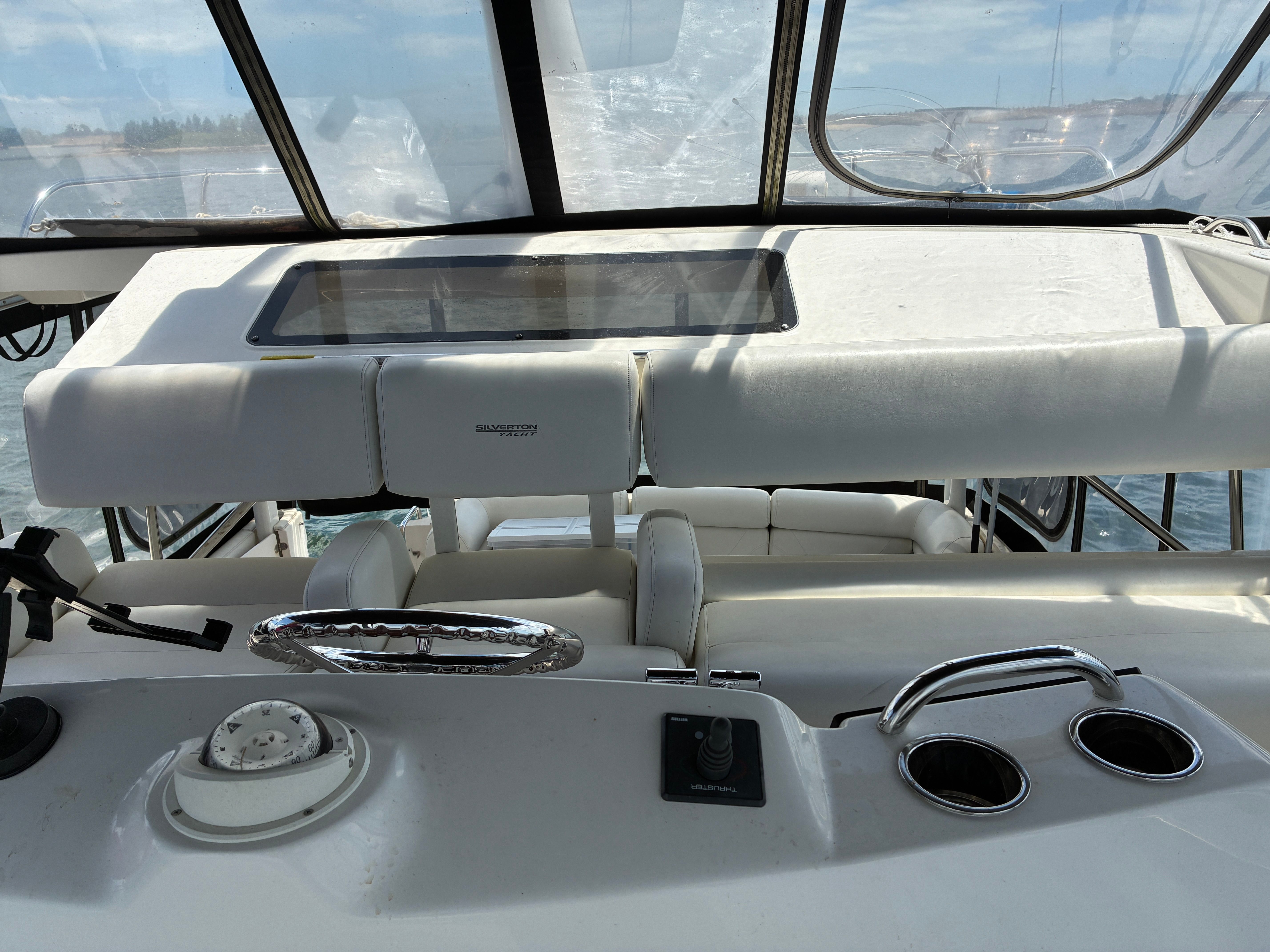 The cockpit of a 2001 Silverton 392 Motor Yacht with steering and instruments.
