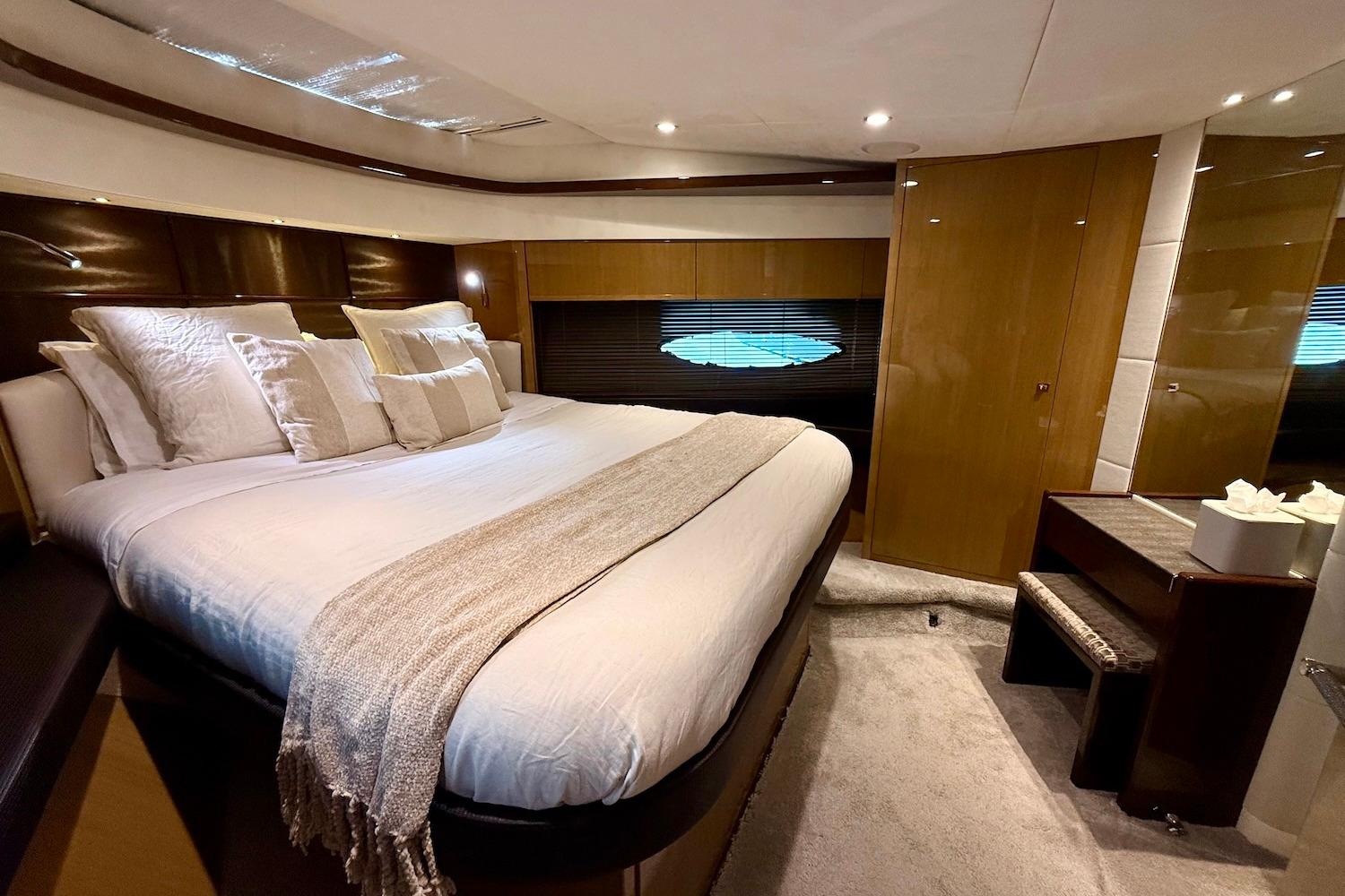 Luxurious bedroom interior of 2015 Princess V72 yacht with elegant bedding and modern design.