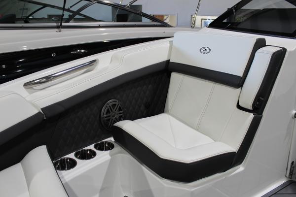 Luxurious seating in 2025 Cobalt R6 boat with cup holders and speaker.