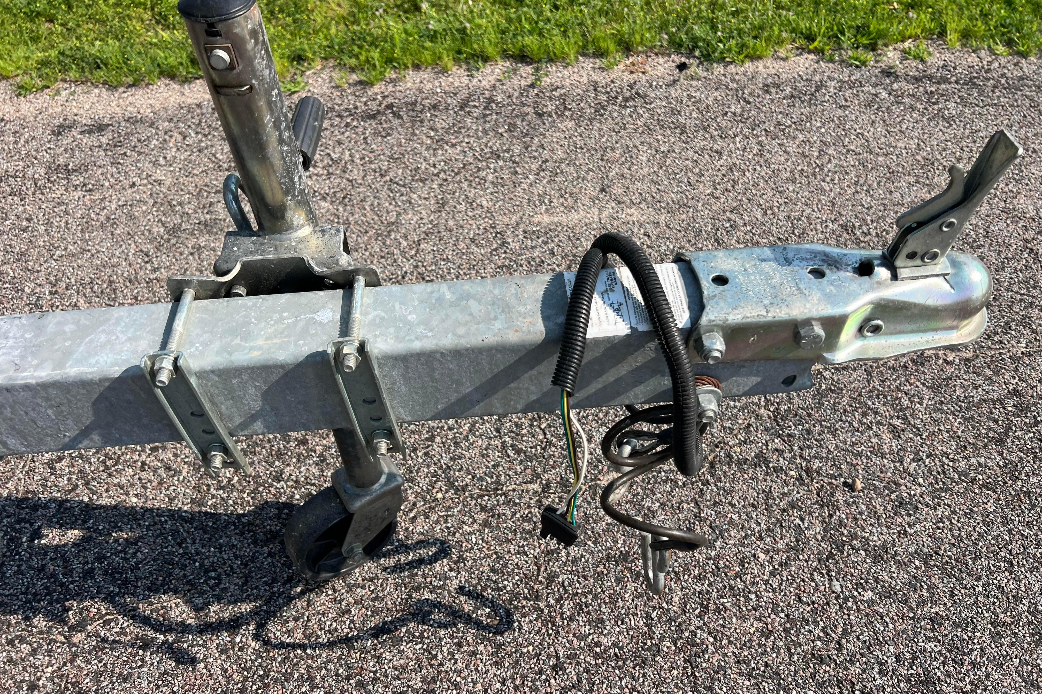 Trailer hitch and wiring for 2012 Sea Fox 206 Center Console on asphalt.