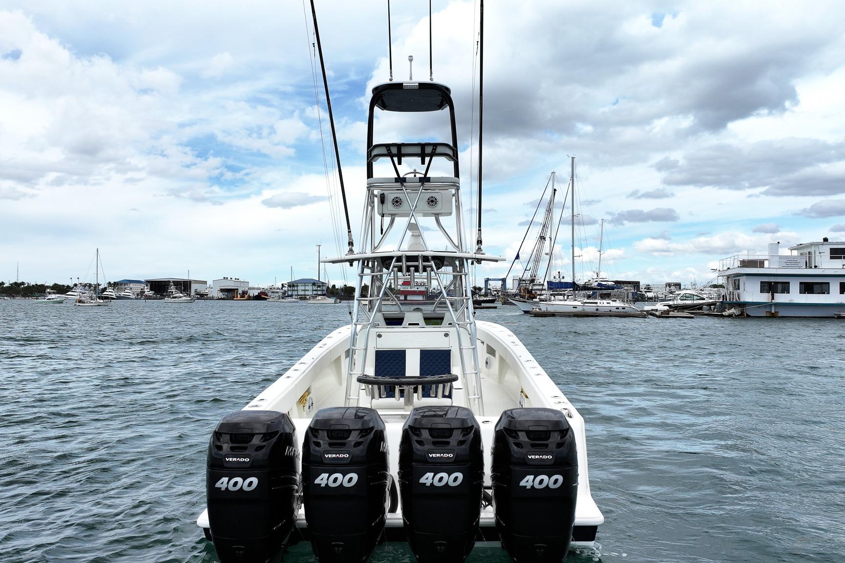 2022 SeaVee 390Z boat with four powerful outboard engines docked in a marina.