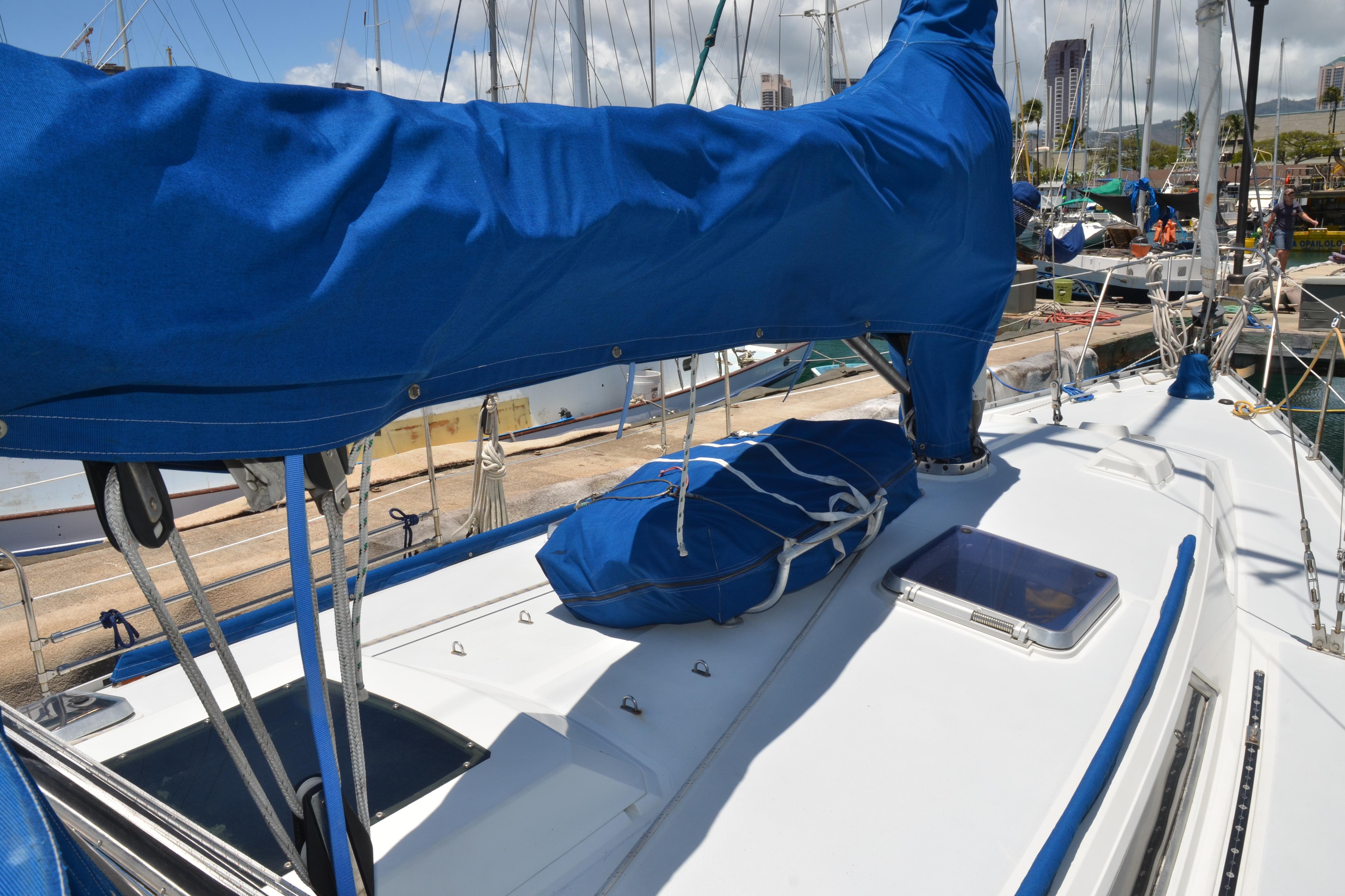 1987 Norseman 400 sailboat deck with blue sail cover in marina.