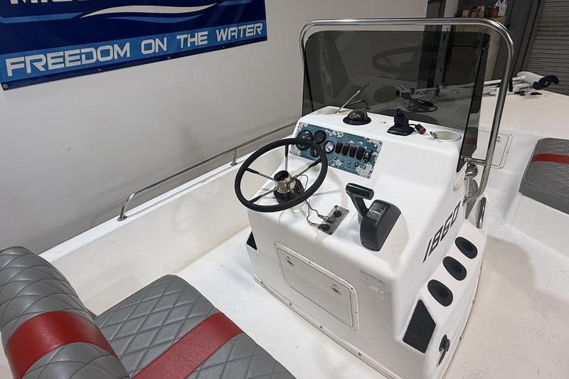 1996 Century 1800 Center Console boat interior with steering wheel and control panel.