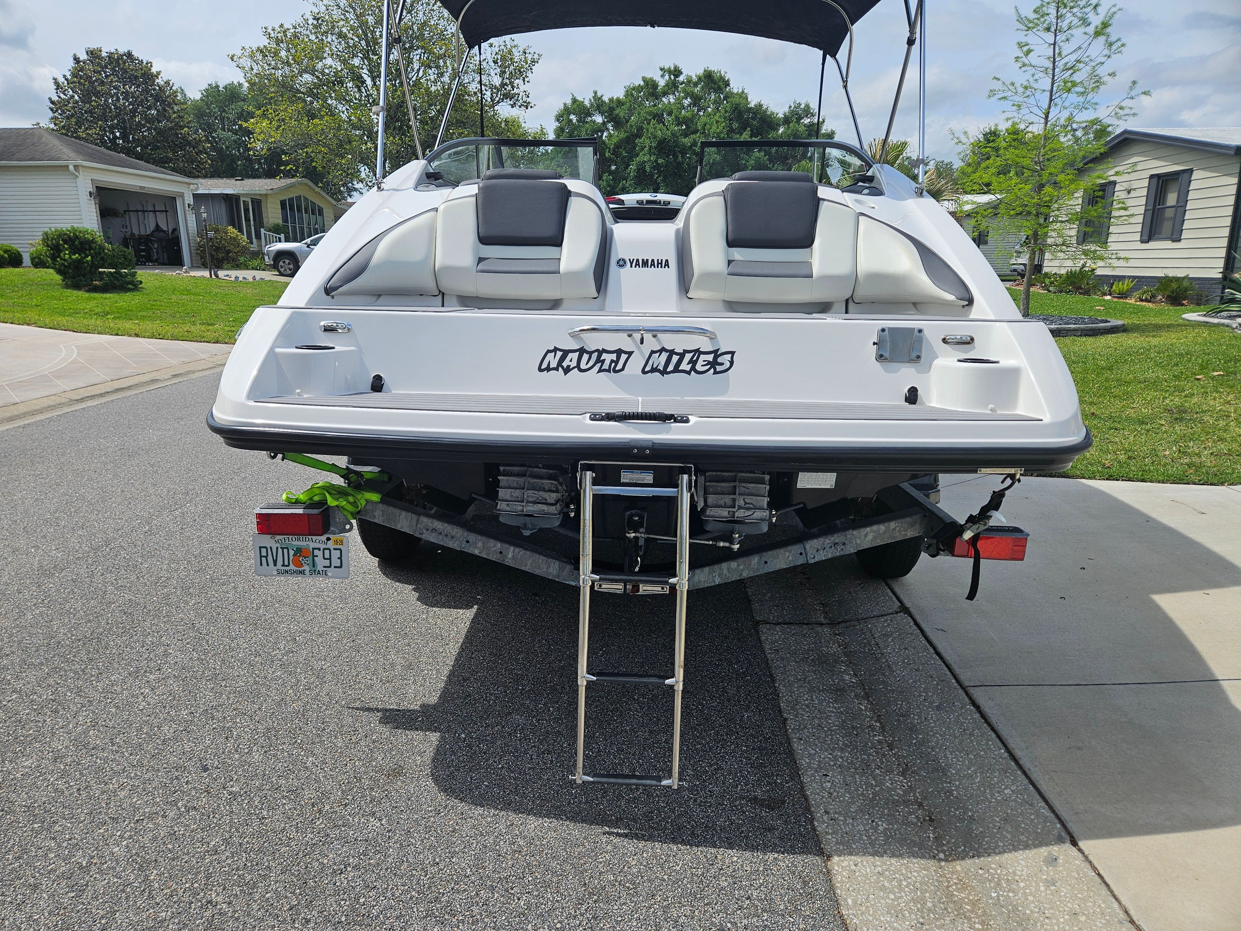 Rear view of a 2022 Yamaha SX210 boat on a trailer.