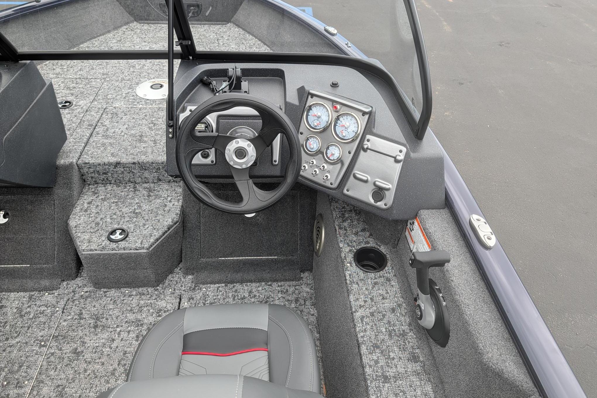 Interior of 2026 Tracker Pro Guide V-175 WT boat with steering wheel and dashboard.