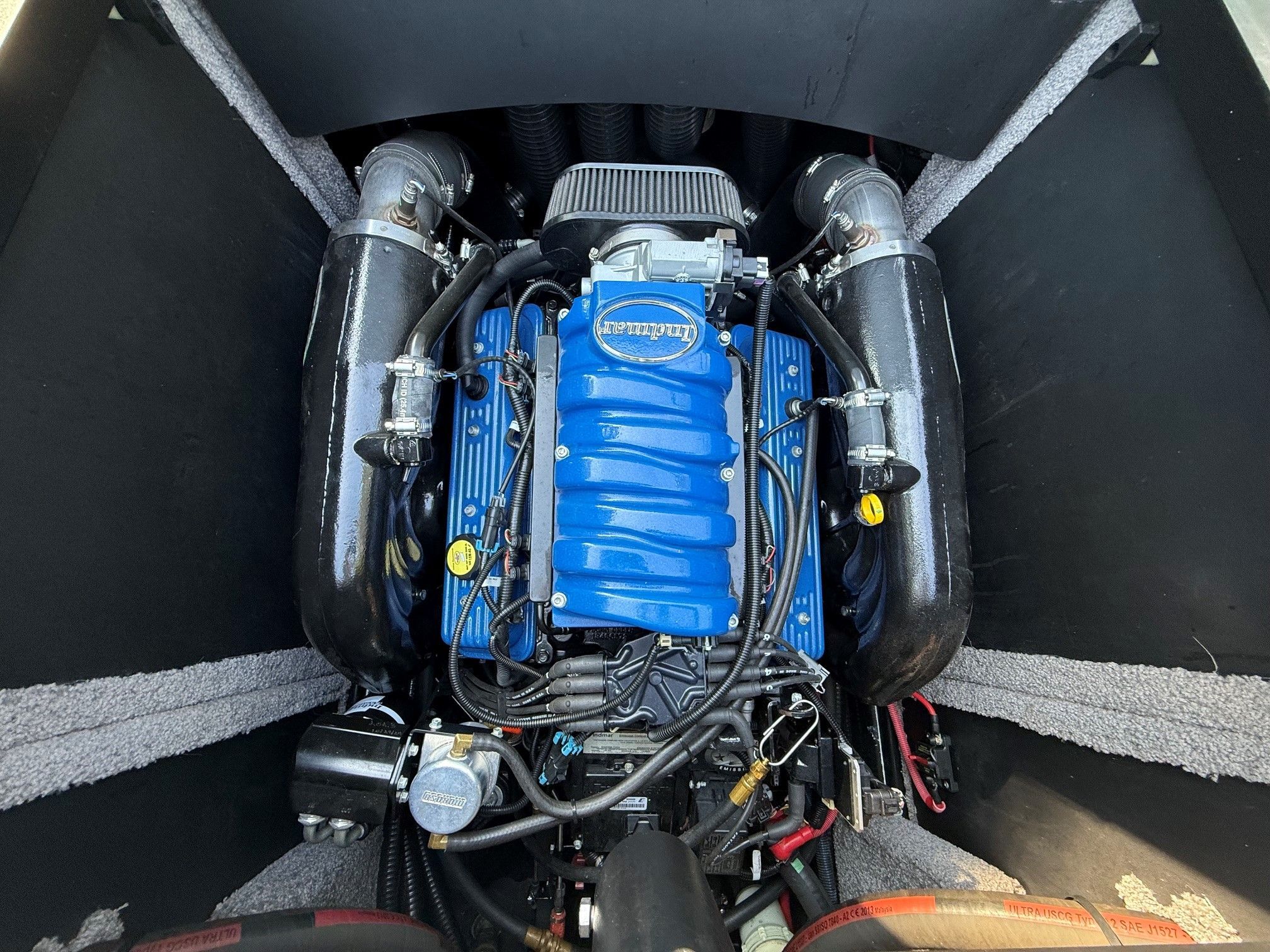 Engine compartment of a 2014 Supra SC350 with a blue engine block.