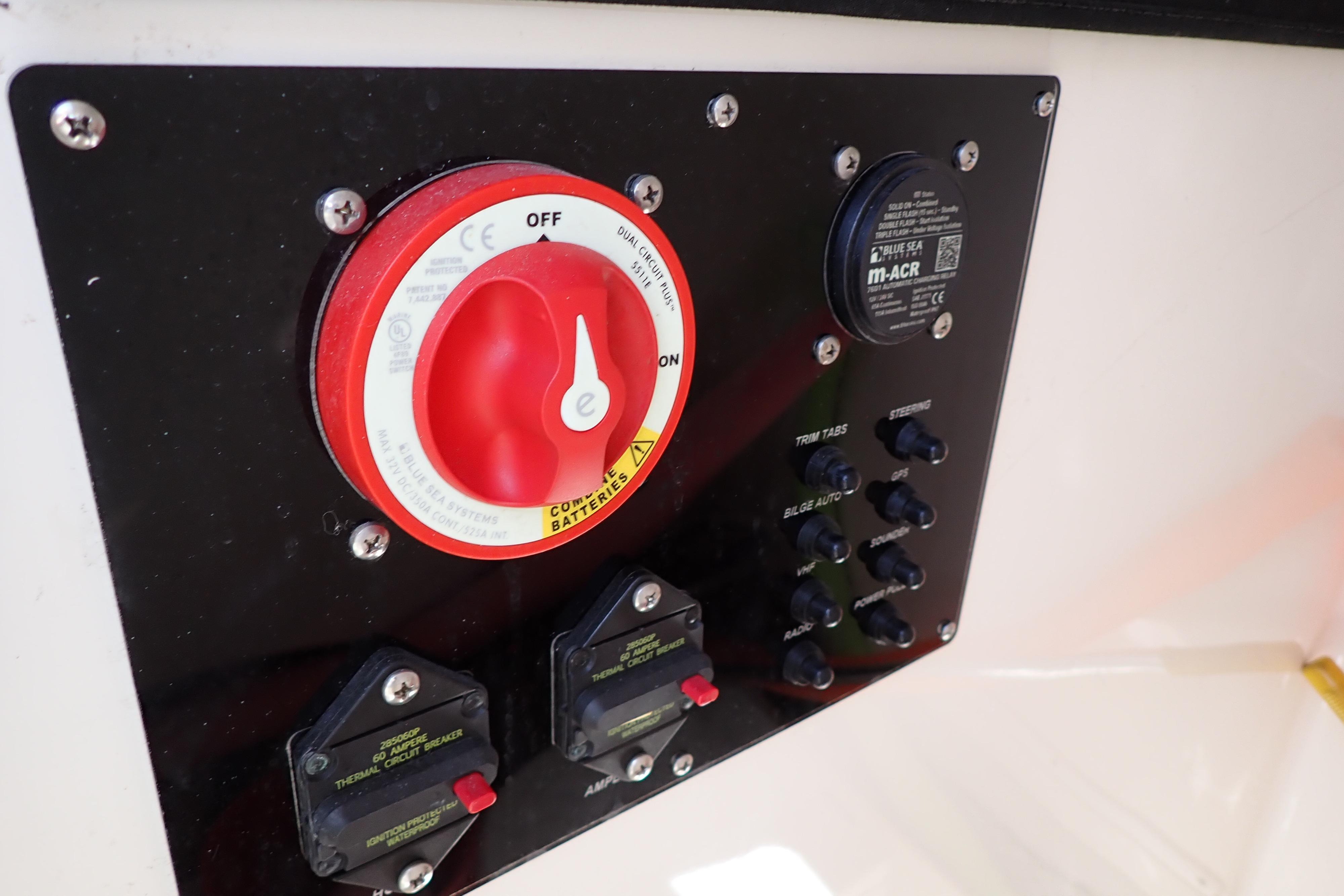 Control panel of 2006 Robalo R220 Center Console boat with switches and circuit breakers.