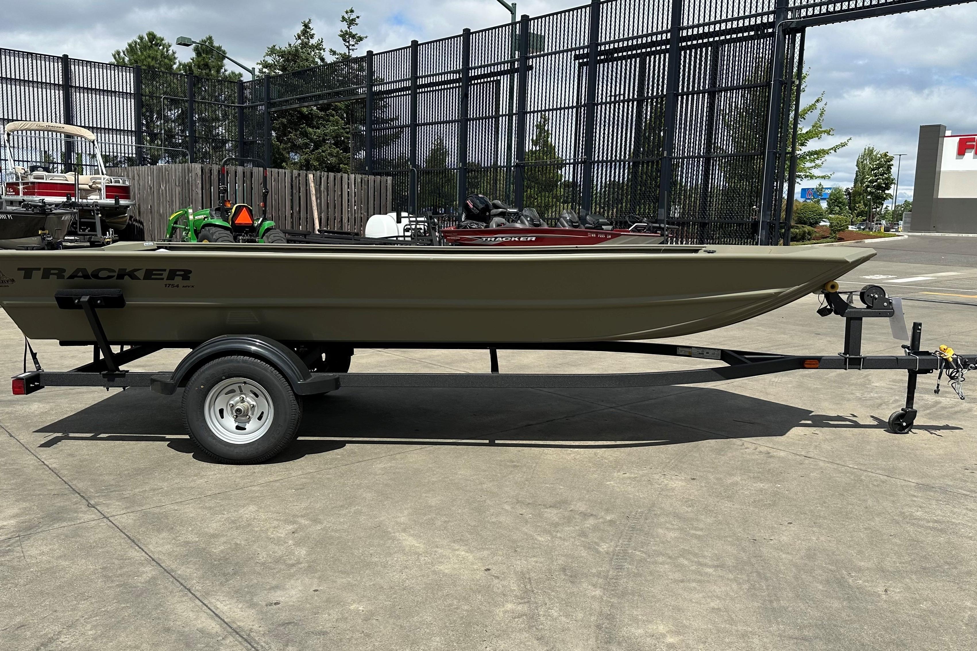 2026 Tracker Grizzly 1754 Utility boat on trailer in outdoor setting.
