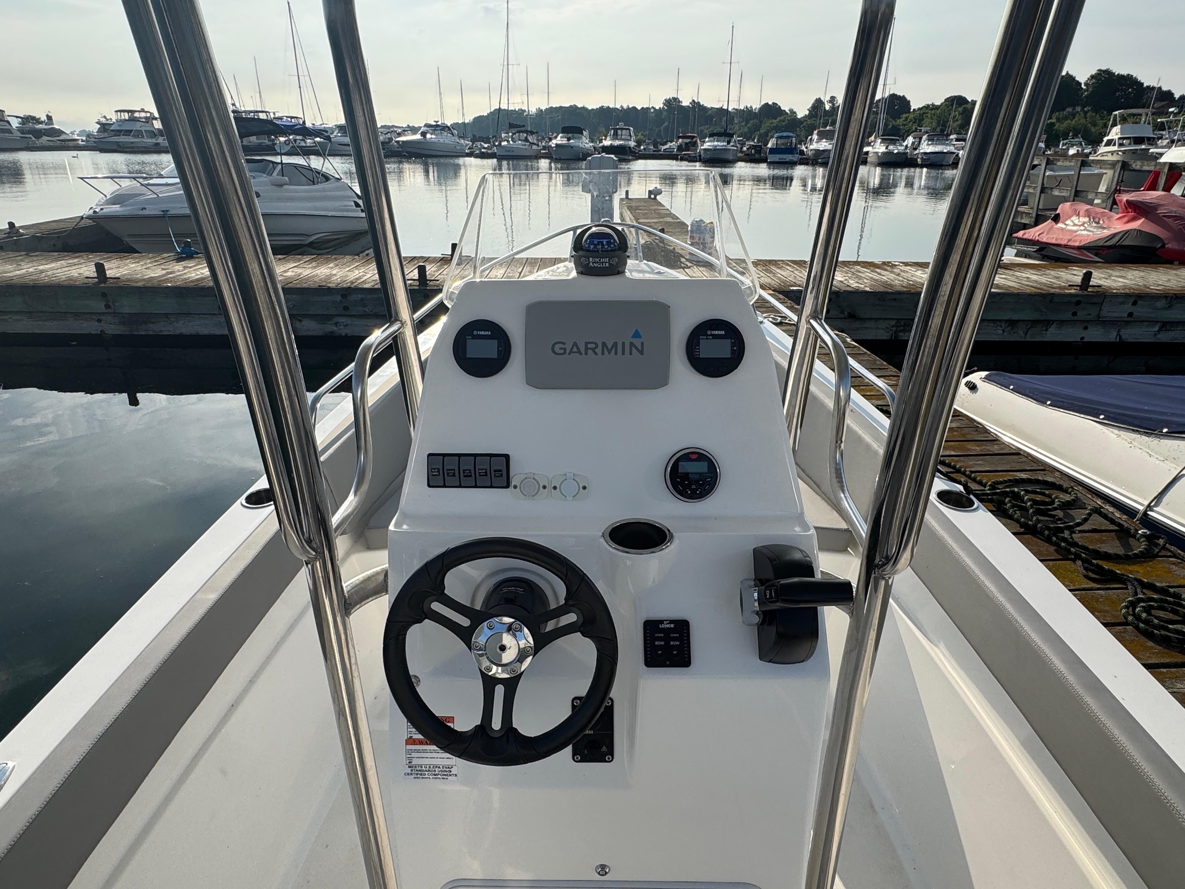 2023 Apex 21 boat dashboard with Garmin navigation, docked at marina.