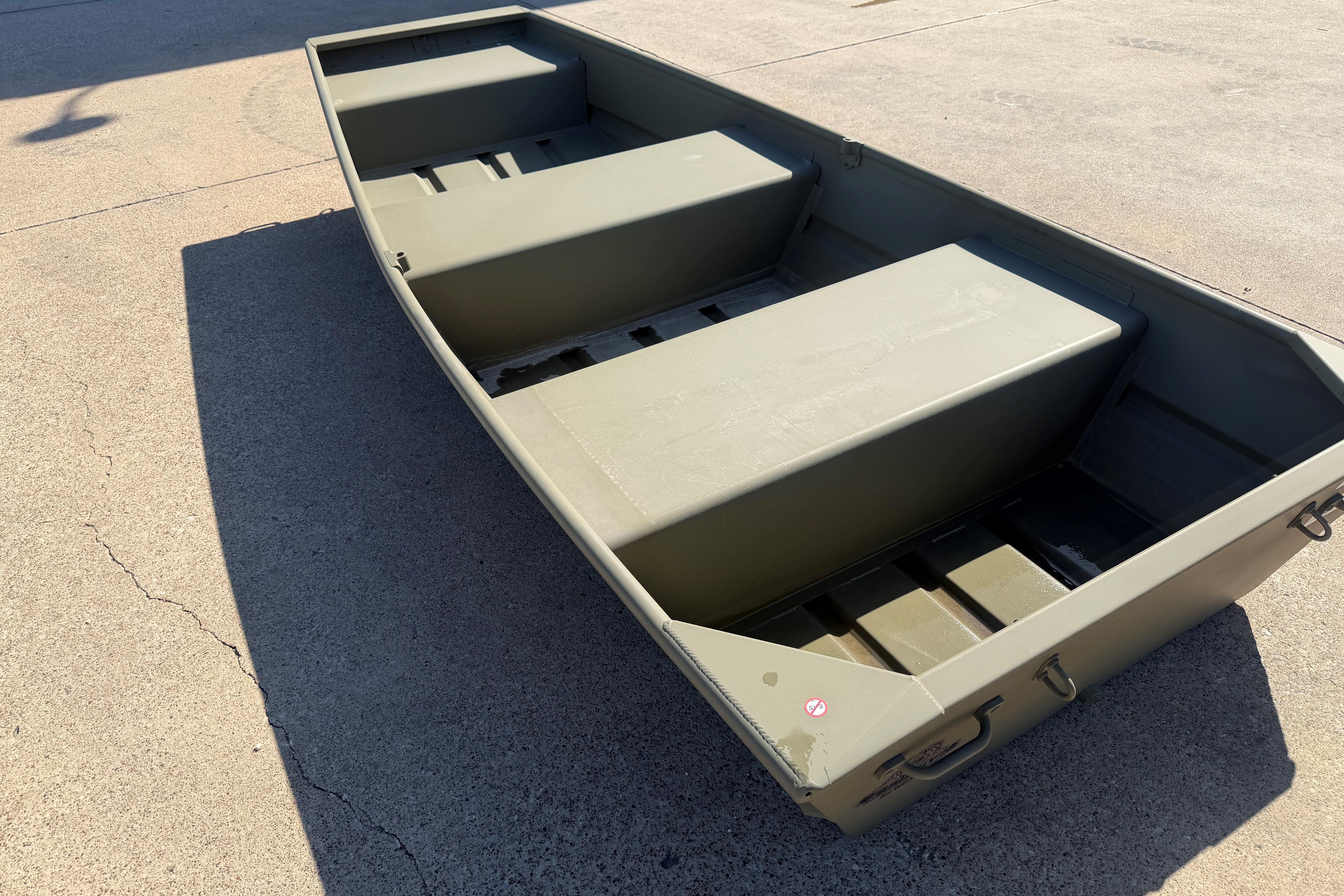 2026 Tracker Grizzly 10 Jon boat on concrete surface, showcasing its sturdy design.