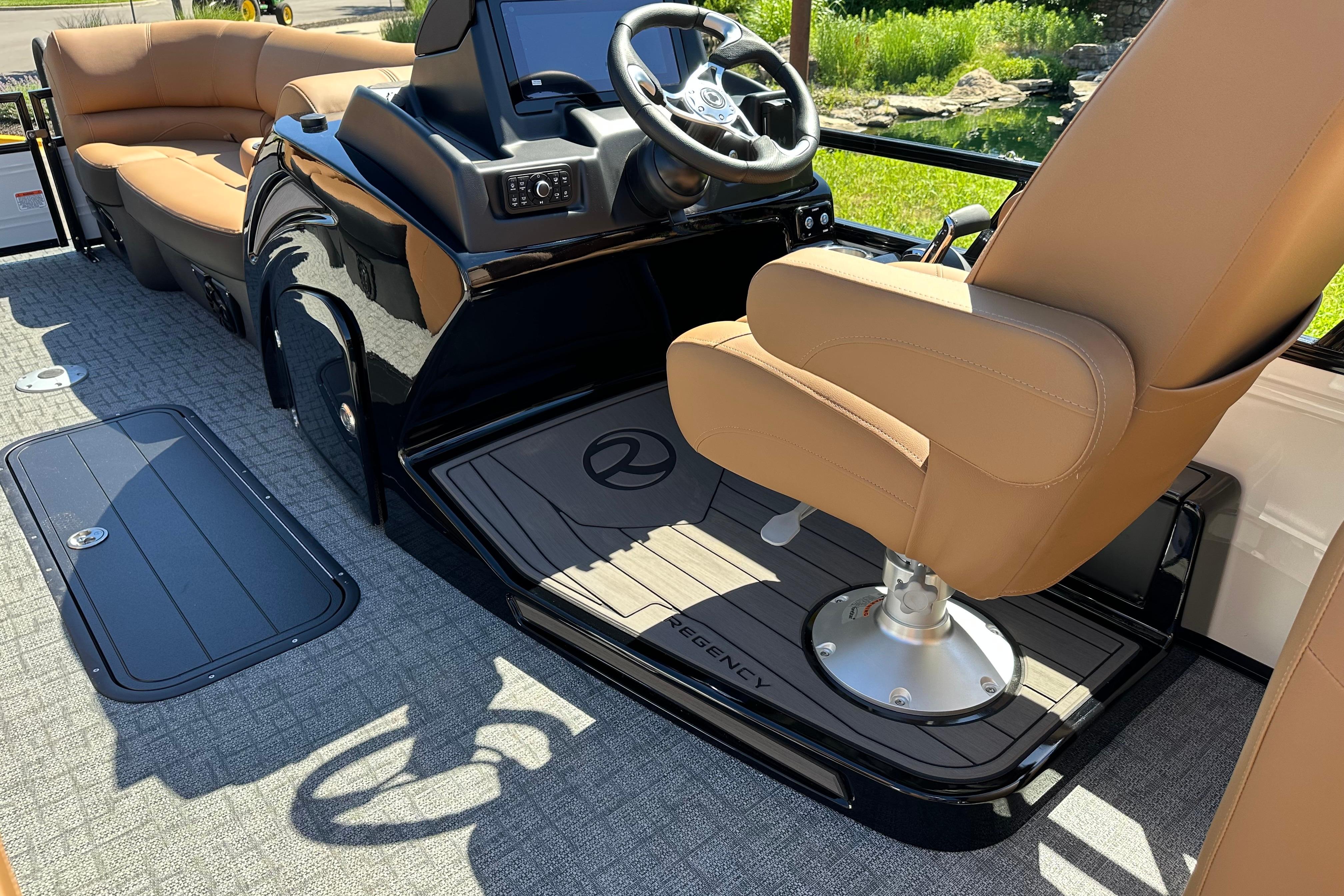 Luxurious 2026 Regency 230 DL boat interior with tan seating and modern helm.