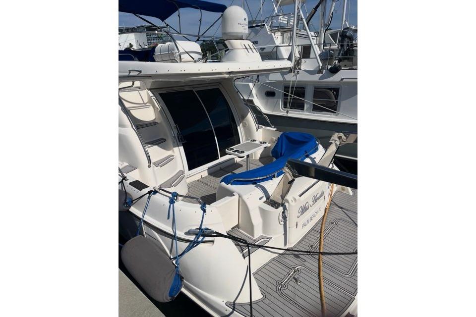 1999 Sealine F44 yacht docked, featuring spacious deck and modern design.