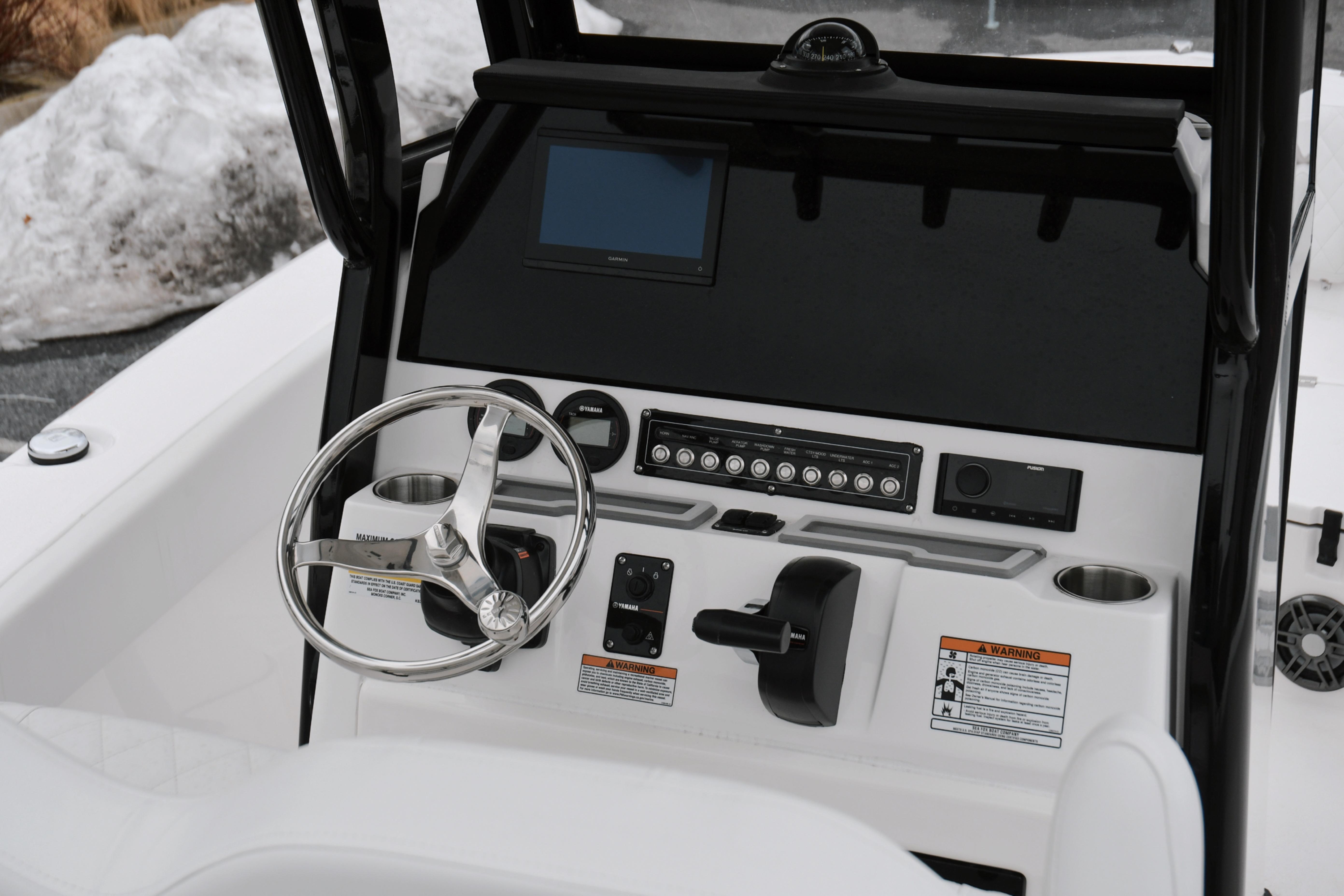 2026 Sea Fox 228 Commander boat dashboard with steering wheel and control panel.