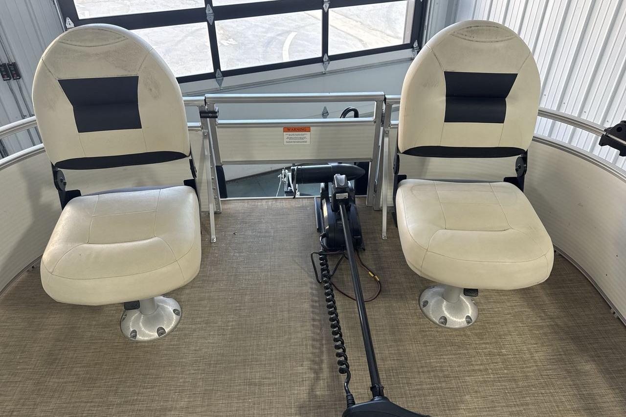 2018 Landau Alure 212 Fish boat interior with two swivel seats and fishing equipment.