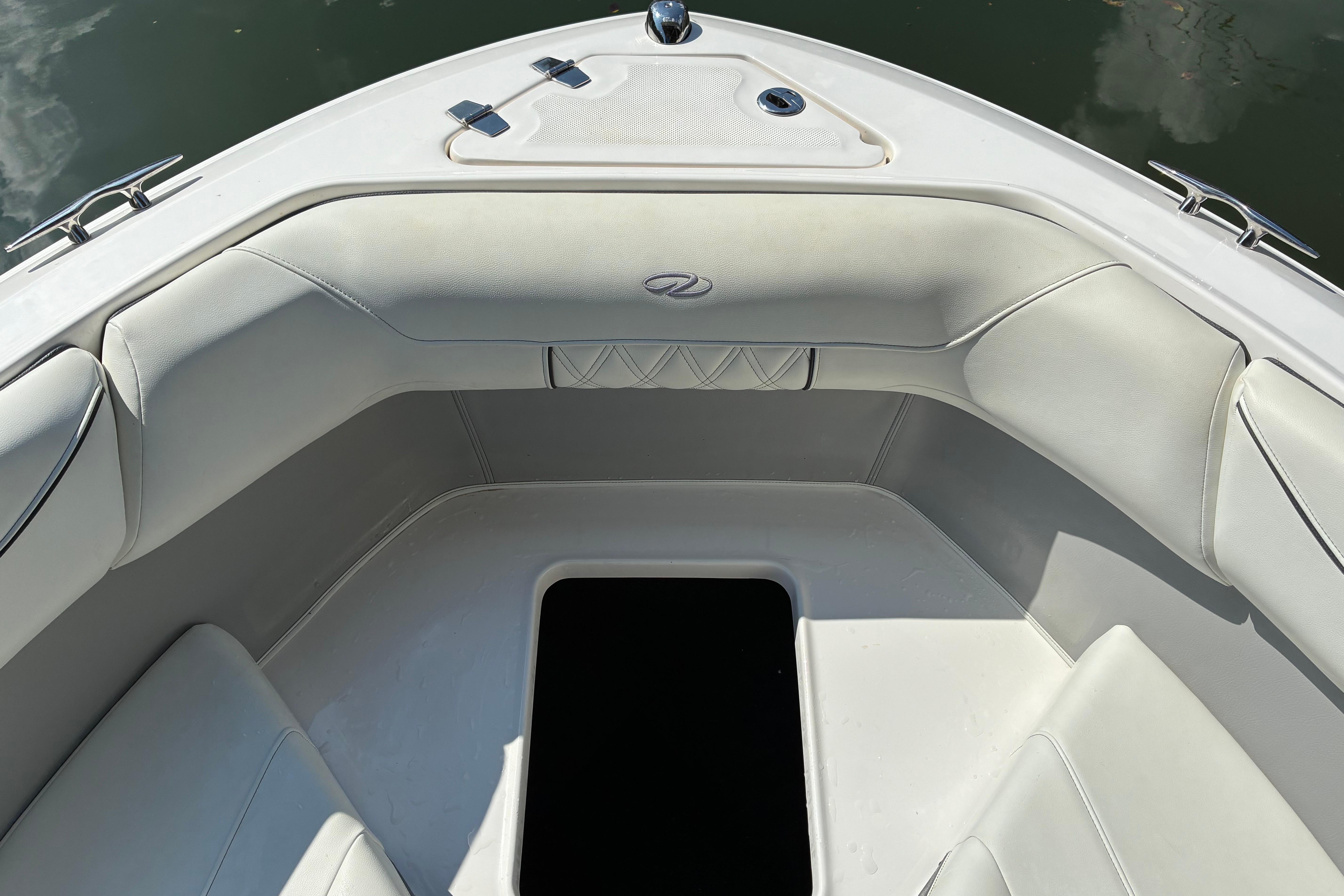 2025 Regal LS2 boat interior with white cushioned seating and storage compartment.