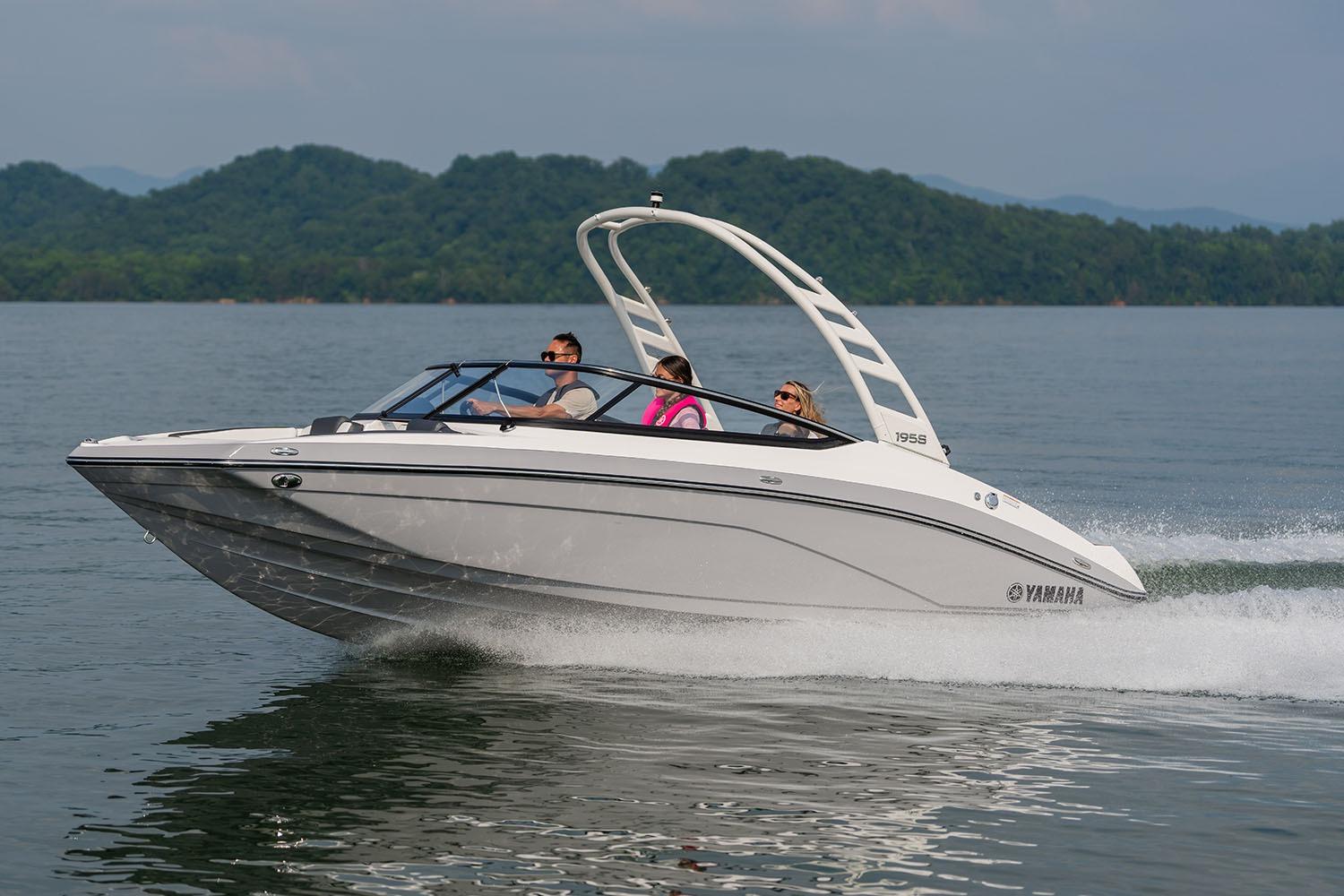 Manufacturer Provided Image: 2026 Yamaha Boats 195S cruising on a lake with passengers, scenic mountain backdrop.