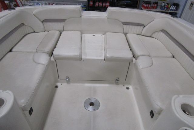 2004 Stingray 240 LR boat interior with white cushioned seating arrangement.