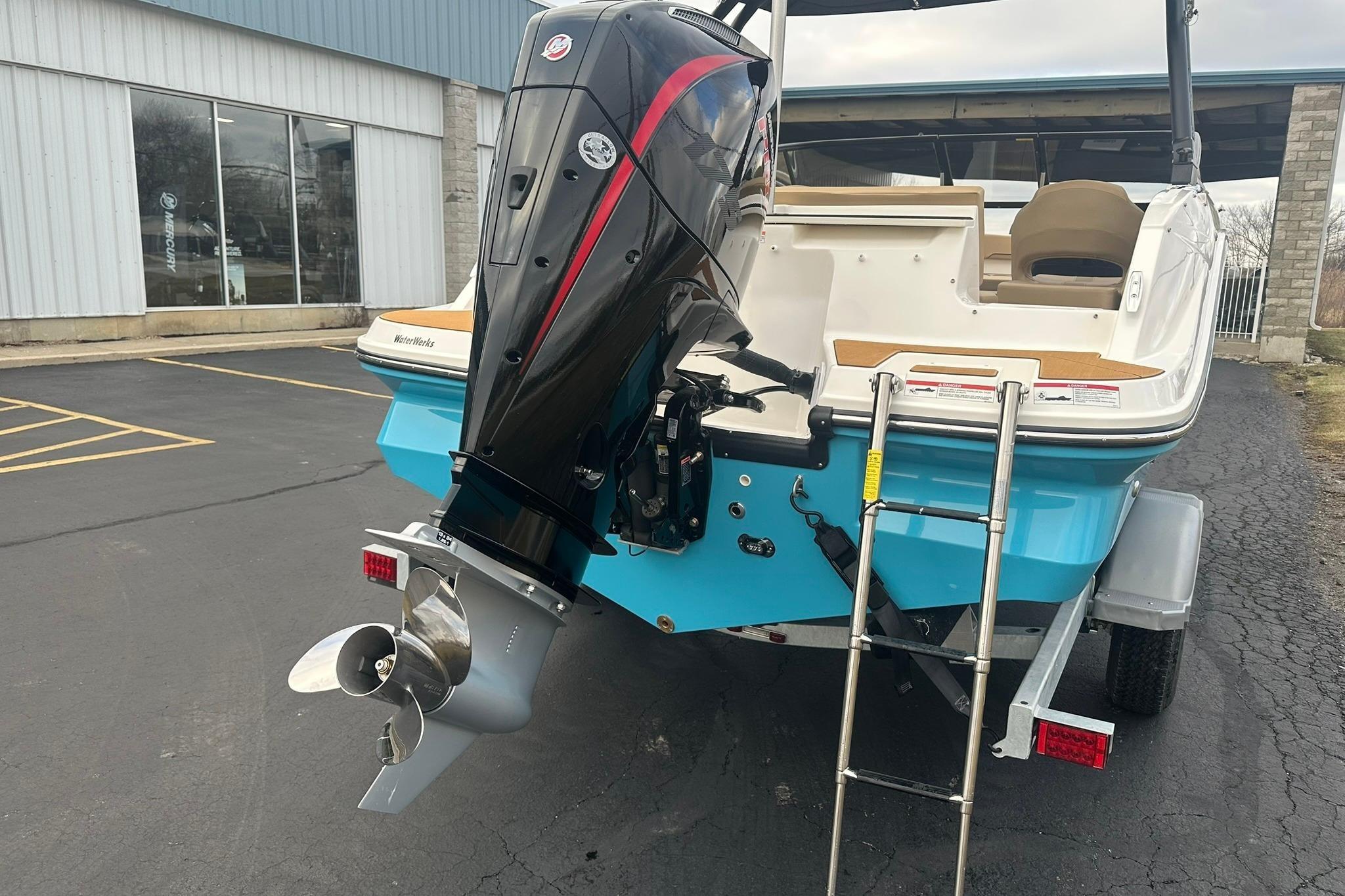 Rear view of a 2026 Bayliner V20 boat with outboard motor.