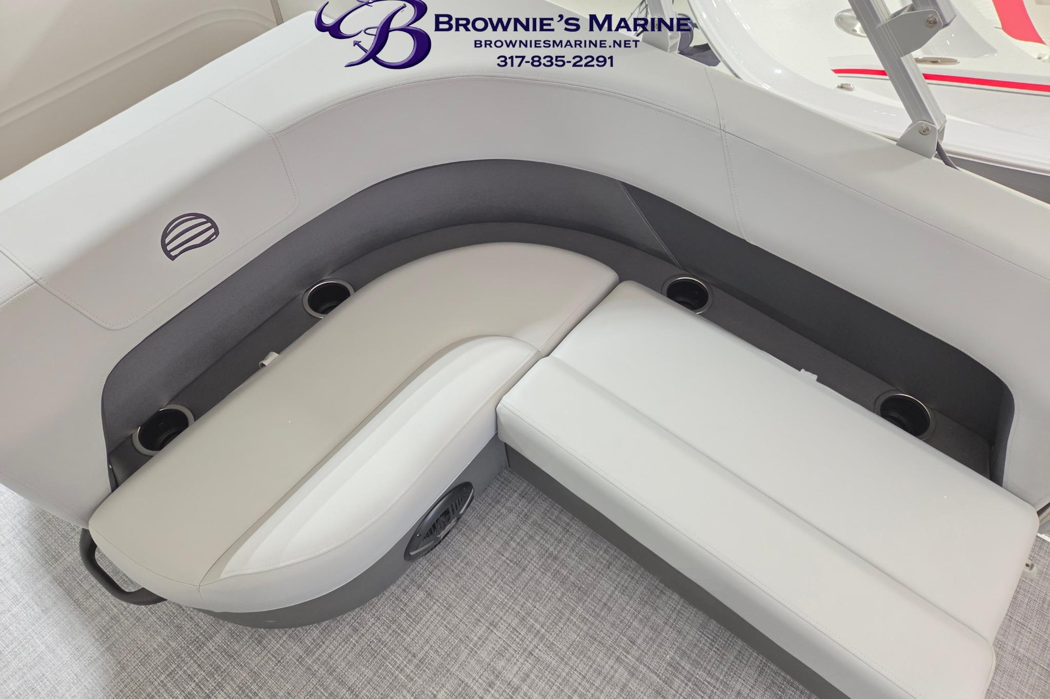2026 Sun Tracker Party Barge 18 DLX interior seating with cup holders, showcased by Brownie's Marine.