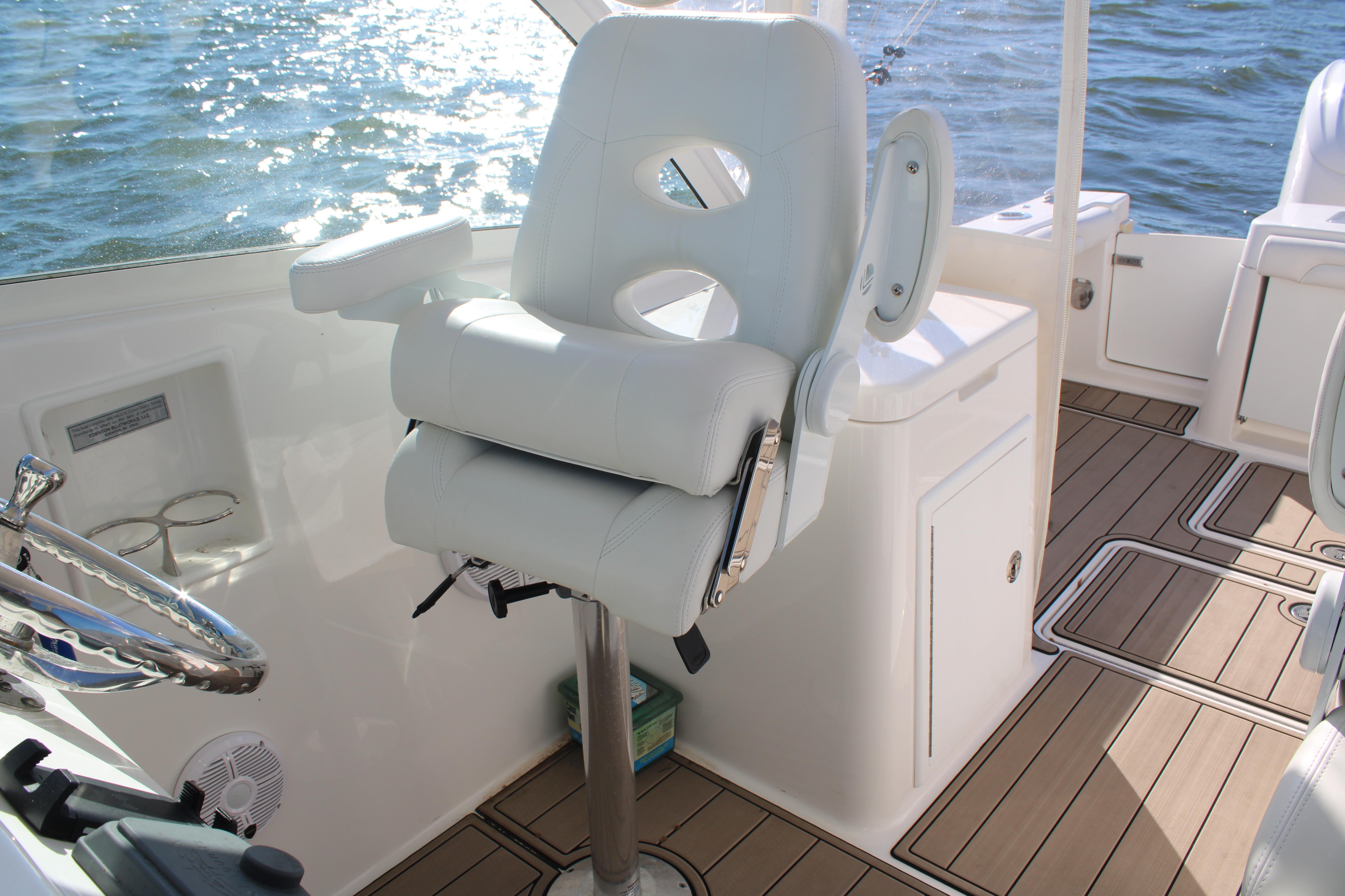 Luxury helm seat on 2022 Albemarle 27 DC boat with teak flooring.