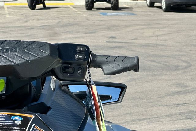 Close-up of a Sea-Doo GTX LTD 325 jet ski handlebar in a parking lot.