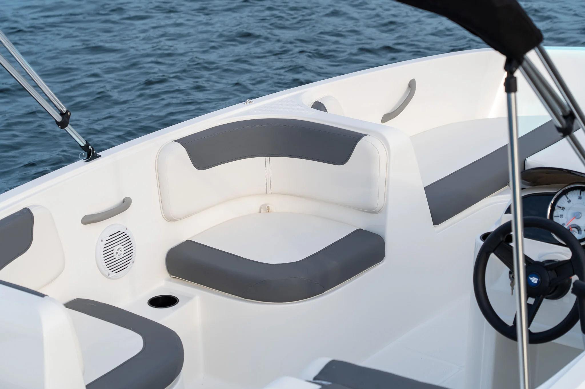Manufacturer Provided Image: 2025 Bayliner Element E16 boat interior with gray seating, steering wheel, and water view.
