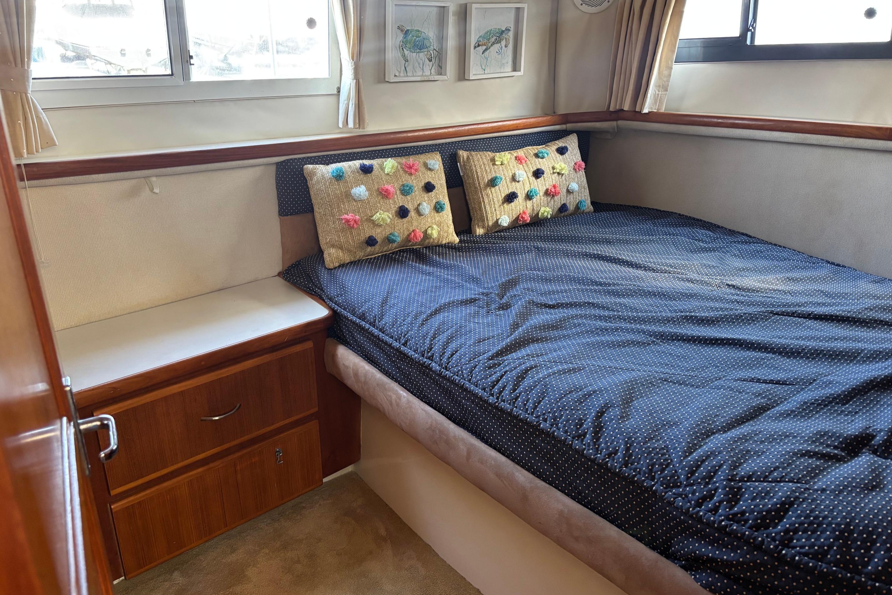 Cozy bedroom in 1995 Carver 356 Aft Cabin Motor Yacht with polka dot bedding.