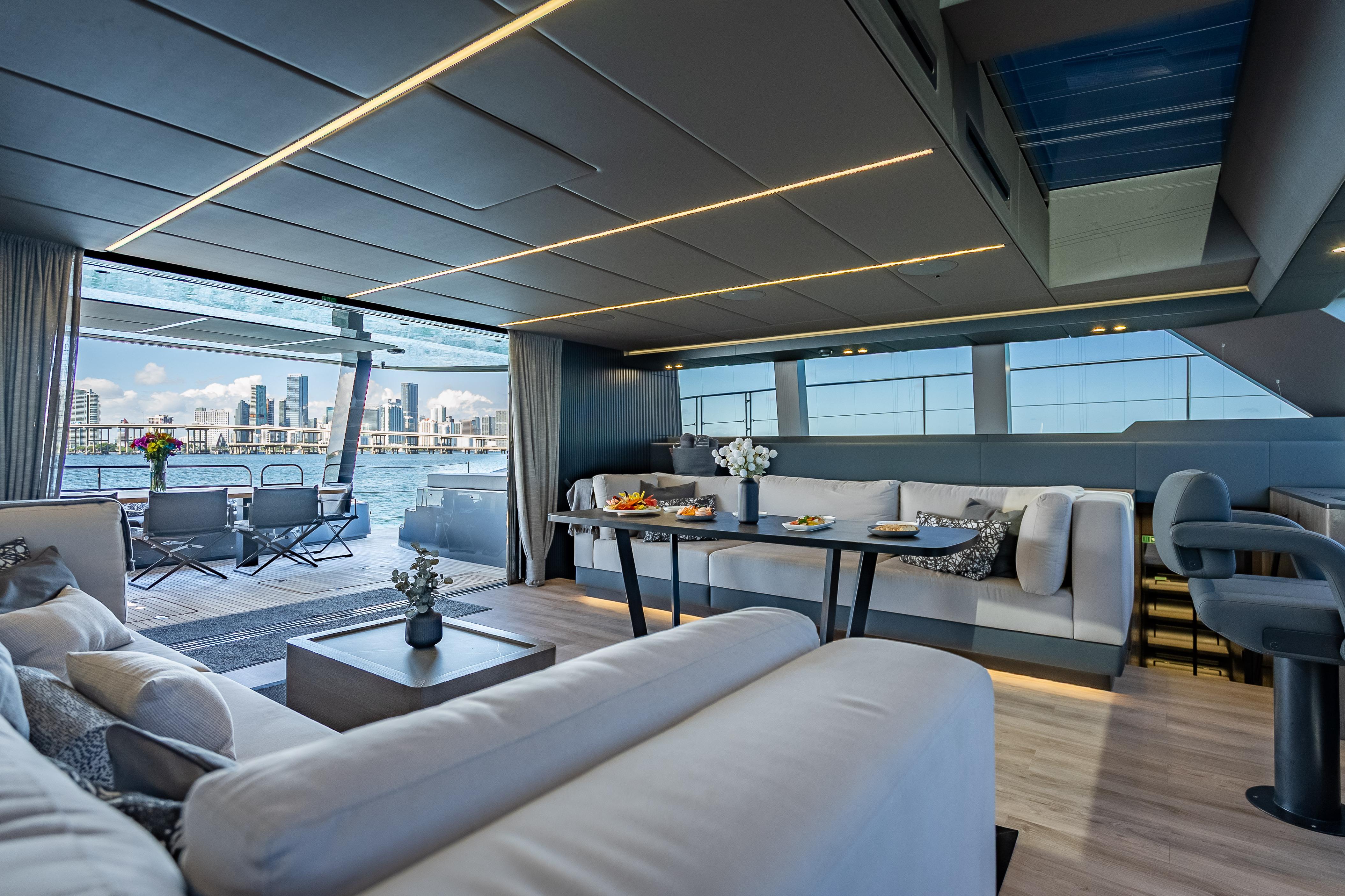 Luxurious interior of 2026 Sunreef 60 Power yacht with city skyline view.