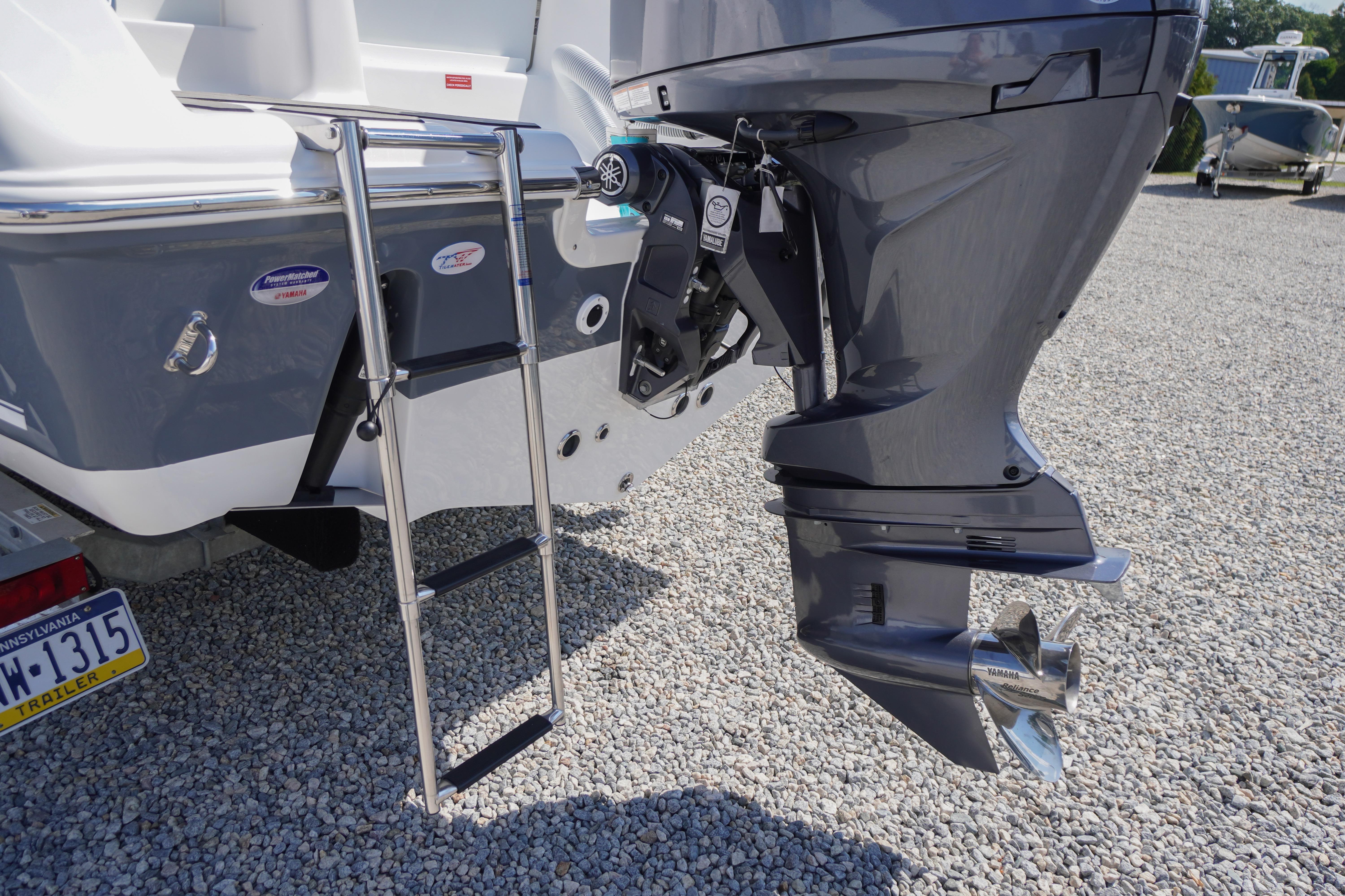 2026 Tidewater 220 CC Adventure boat with Yamaha outboard motor and ladder.