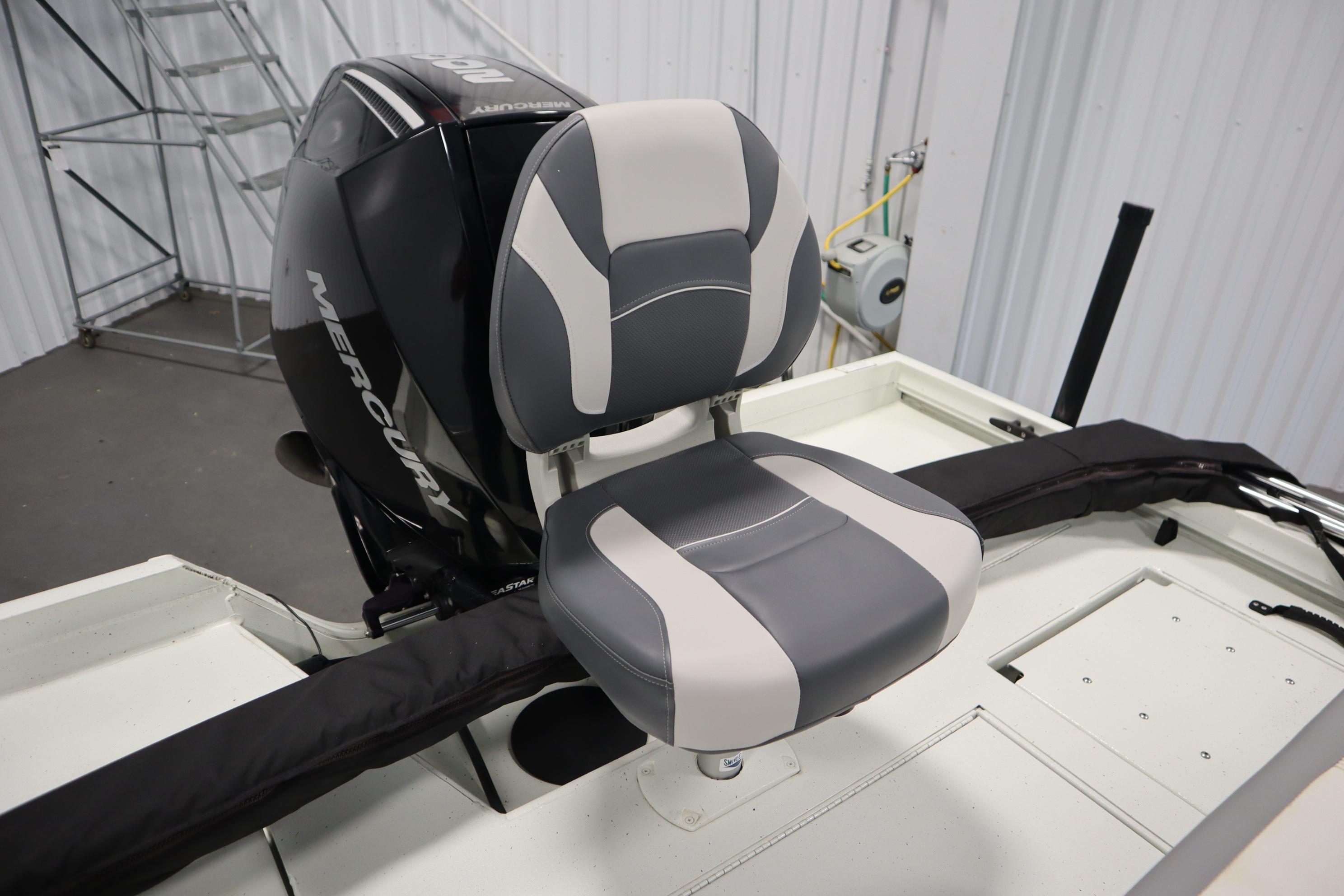 2022 Crestliner 2200 CC boat seat with Mercury outboard motor in a garage setting.