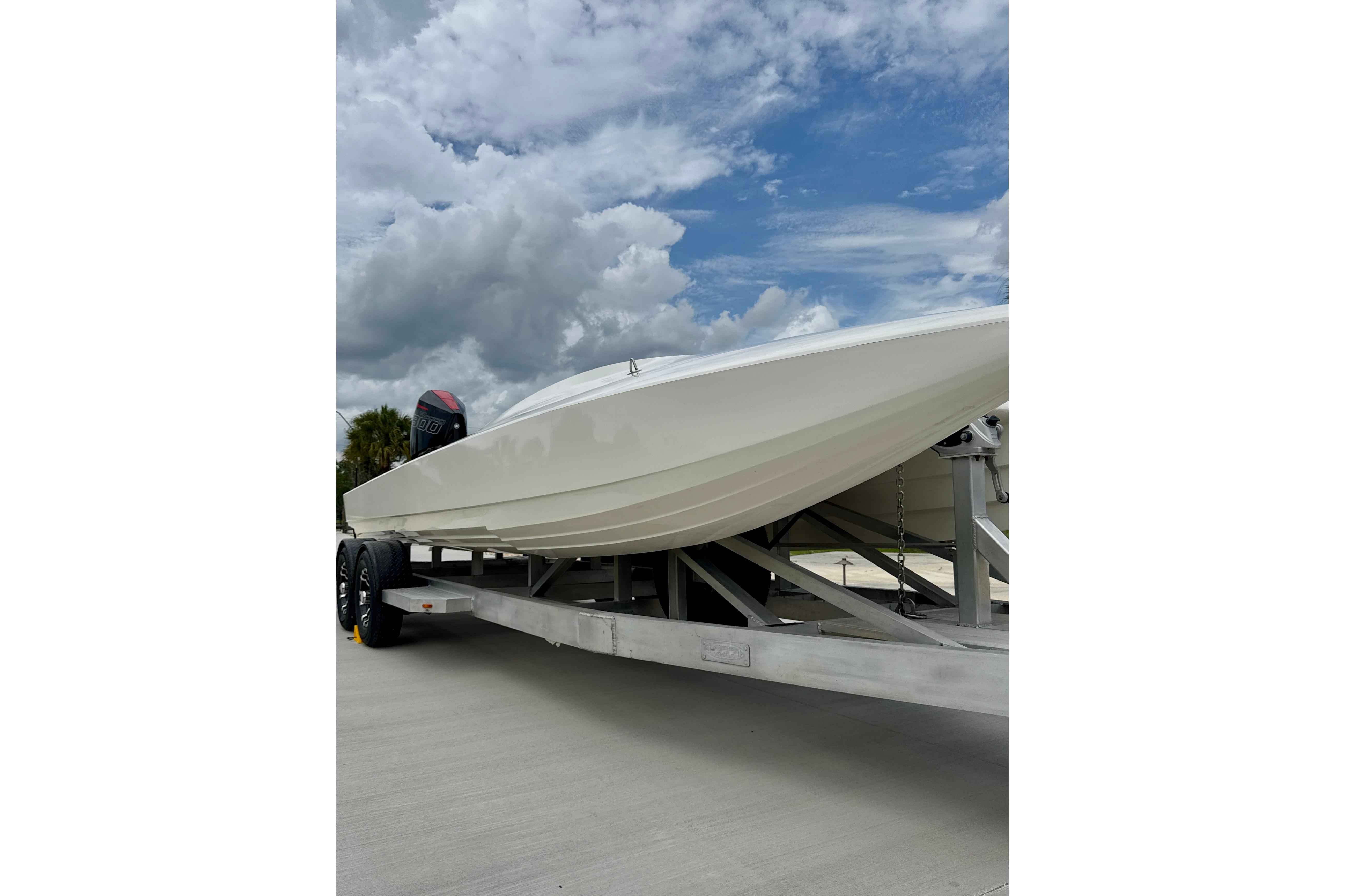 2016 Argo 23 boat on trailer under cloudy sky.