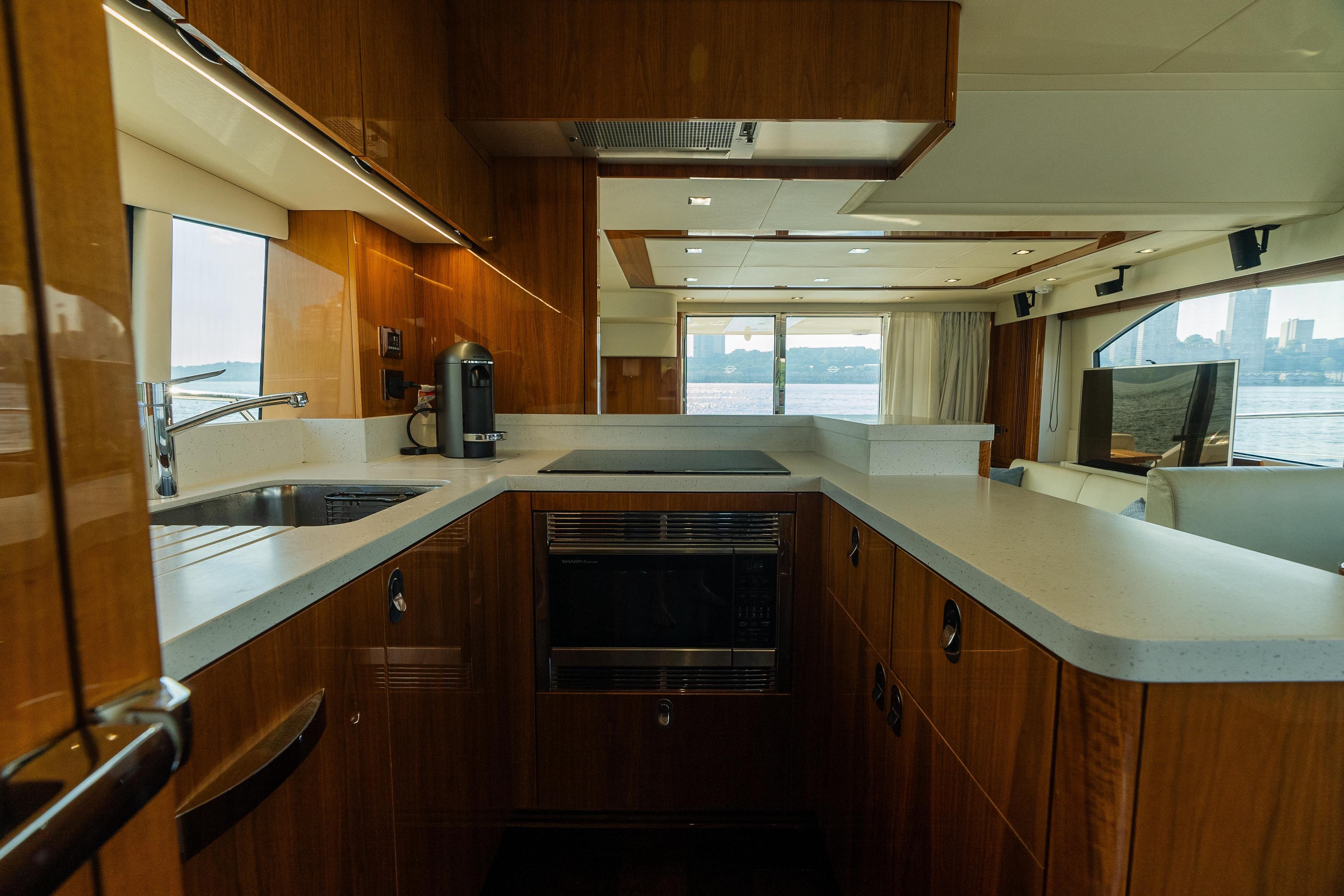 Luxurious kitchen interior of 2016 Sunseeker Manhattan 65 yacht with modern amenities.