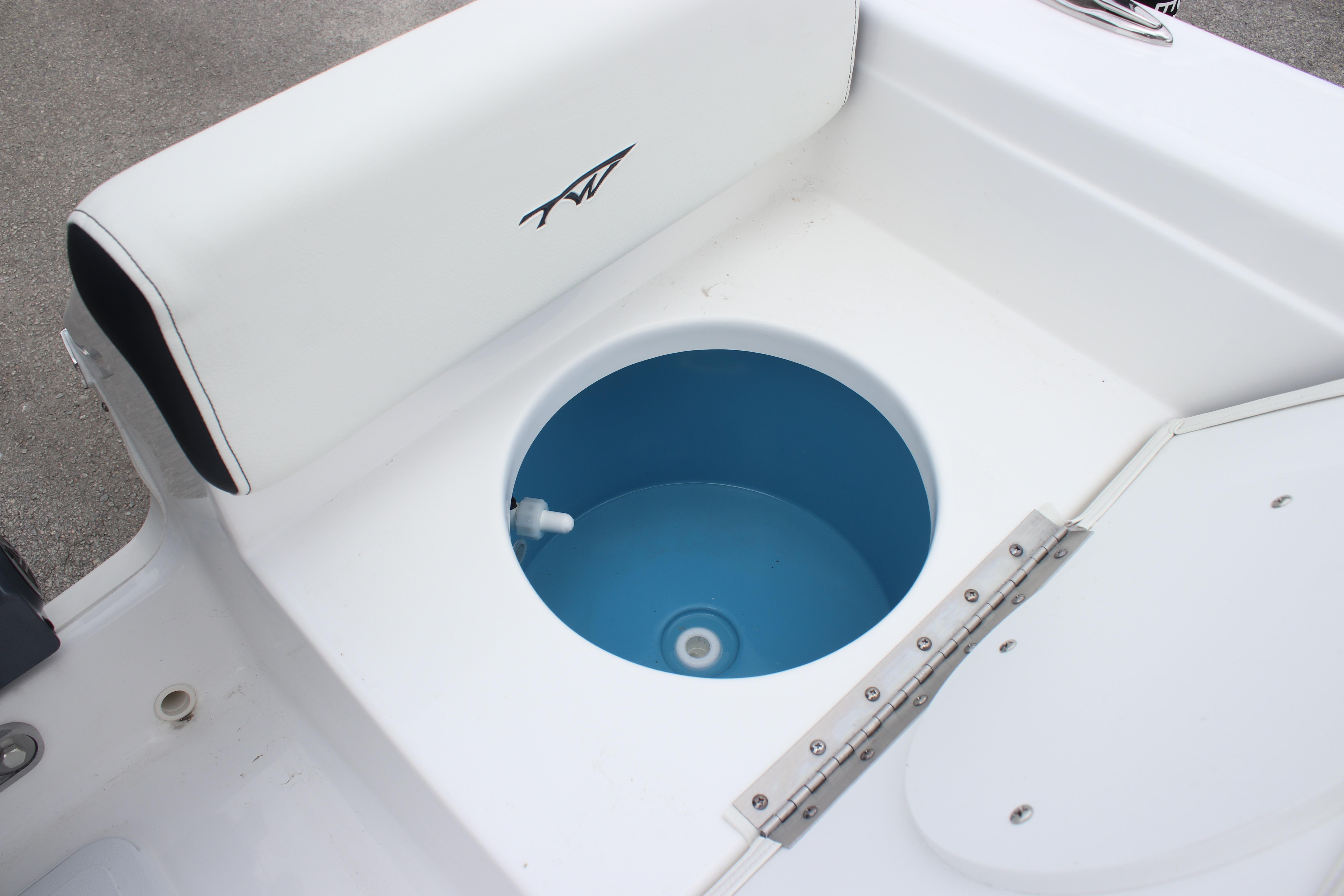 2026 Tidewater 198 CC Adventure boat livewell with white seating and blue interior.