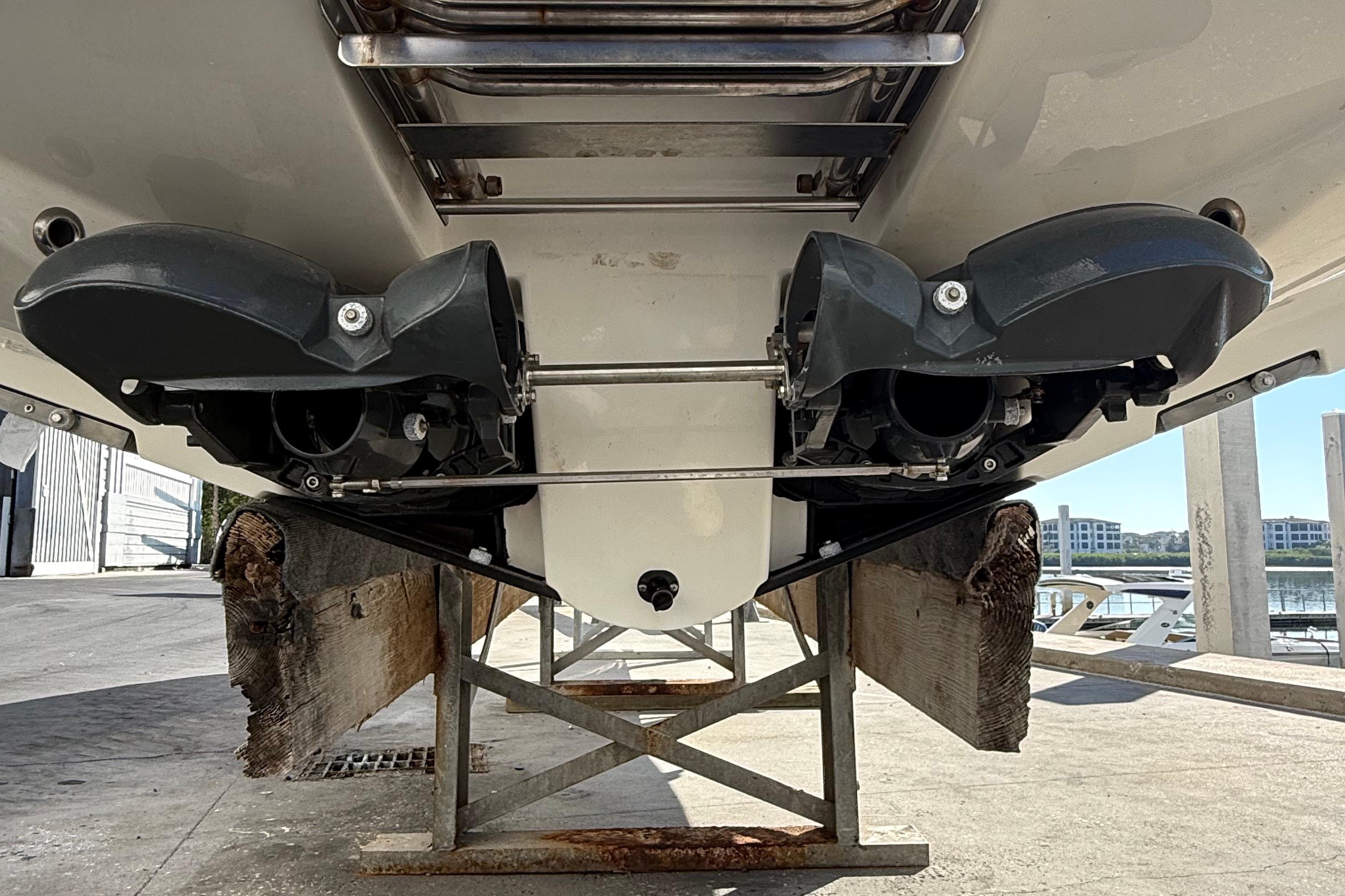 Rear view of 2021 Scarab 255 ID boat on a stand, showcasing dual jet drives.