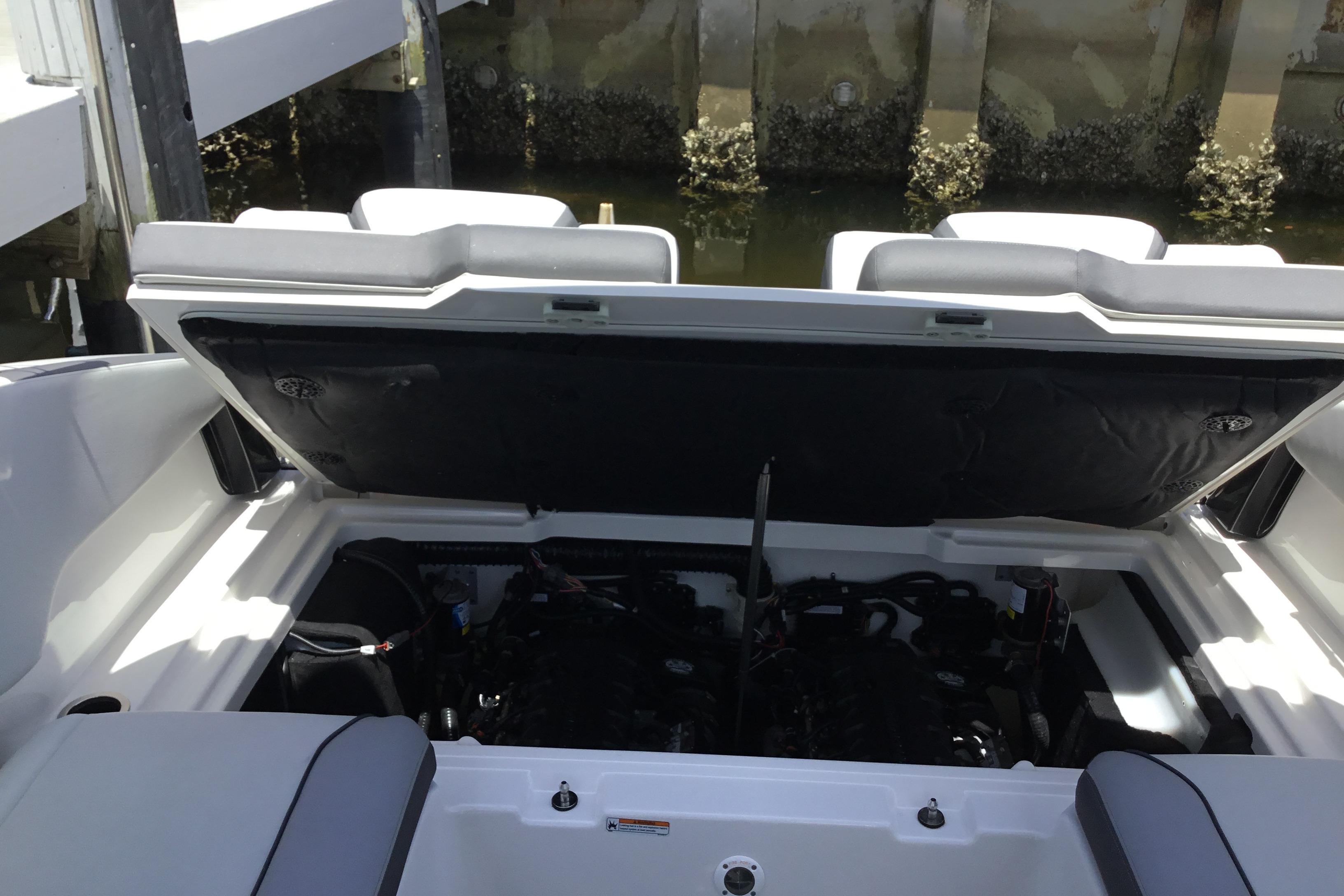 Open engine compartment of 2023 Yamaha Boats 252XE, dockside view.