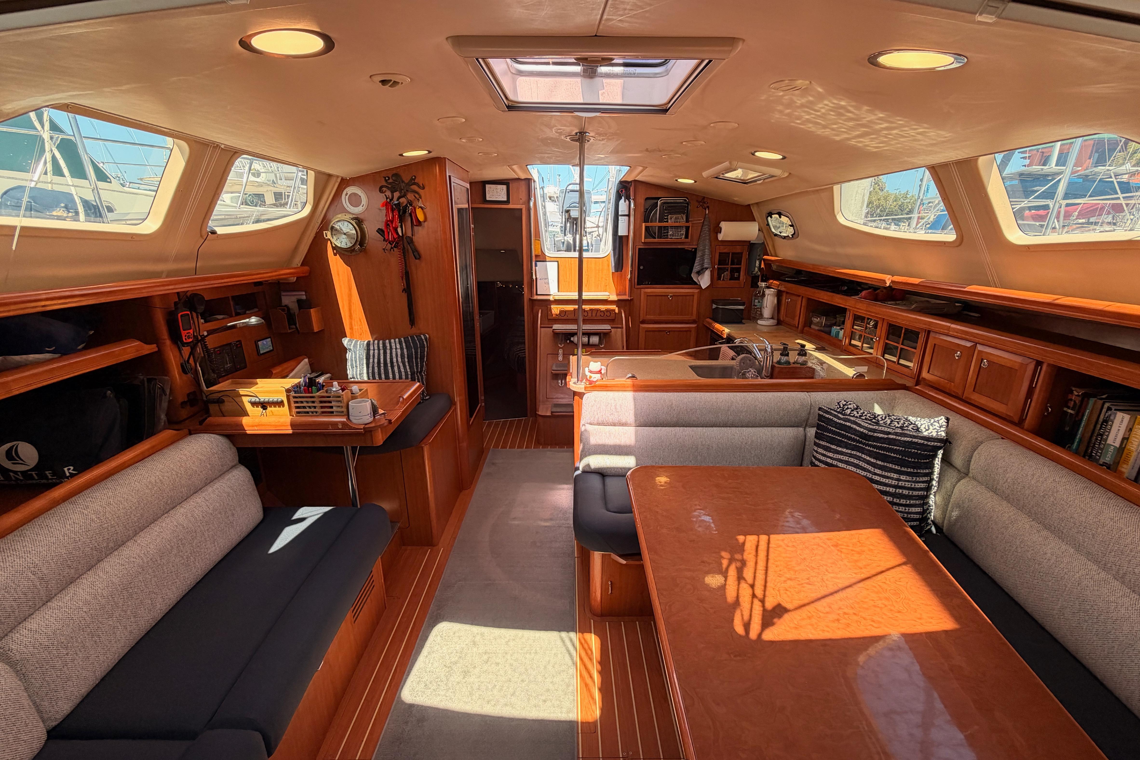 Interior of 2008 Hunter 45 Deck Salon yacht with spacious seating and elegant wood finishes.