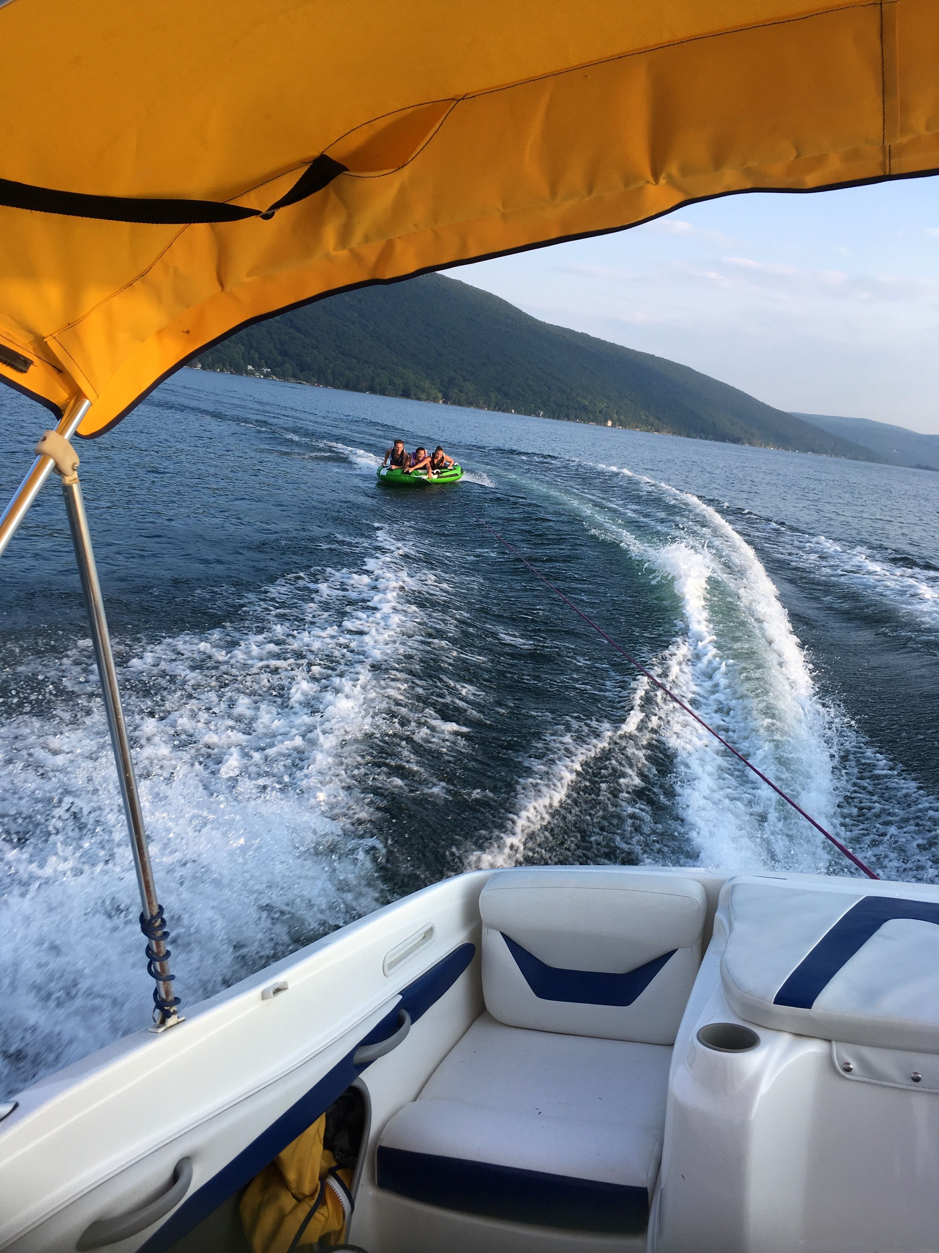 Bayliner 205BR 2005 on a lake with tubing activity.
