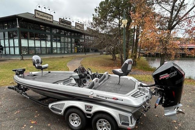 2024 Ranger Z519 Ranger Cup Equipped boat parked near a scenic lakeside building.