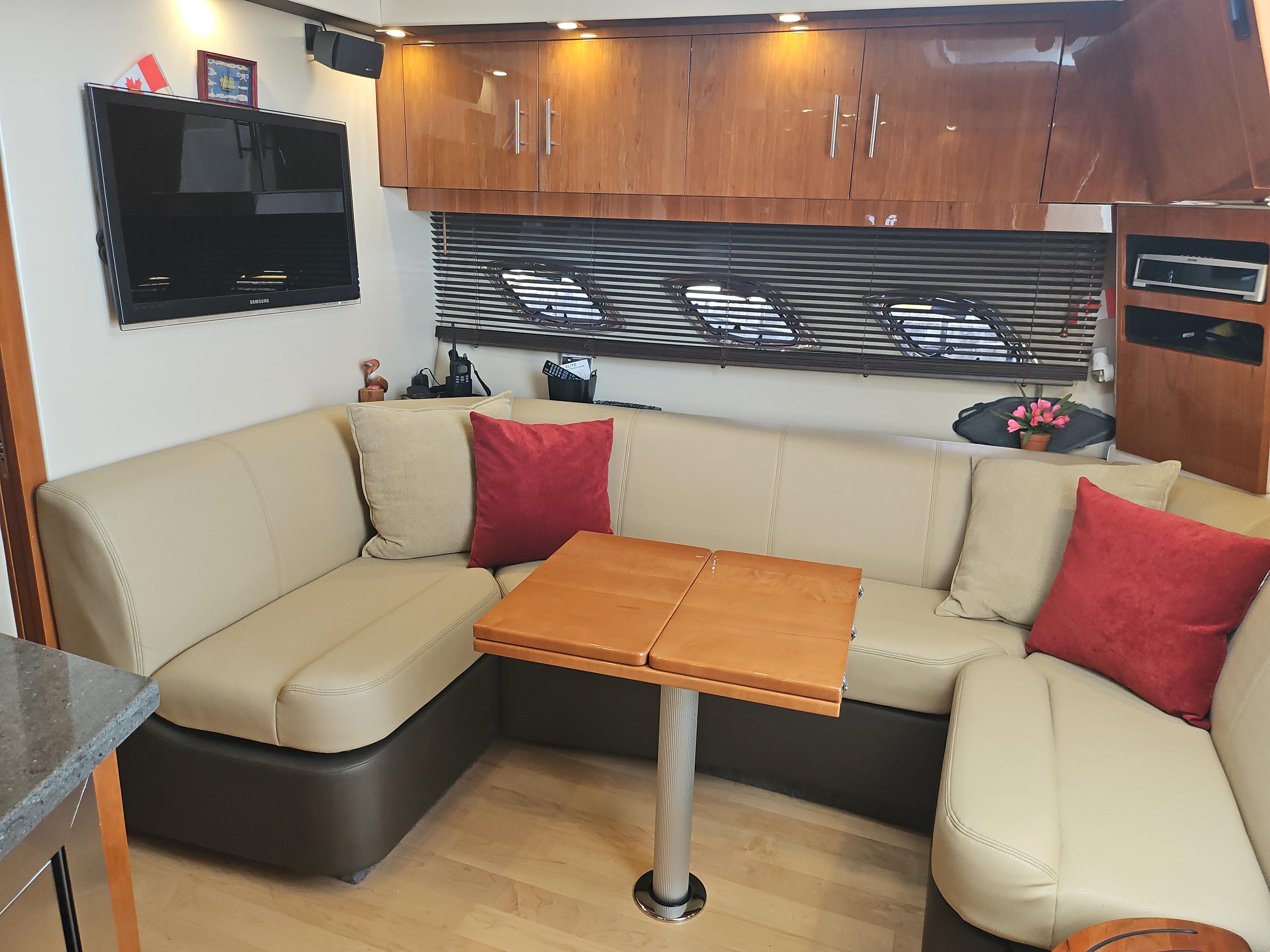 Luxurious interior of a 2011 Regal 42 Sport Coupe with beige seating and wooden accents.