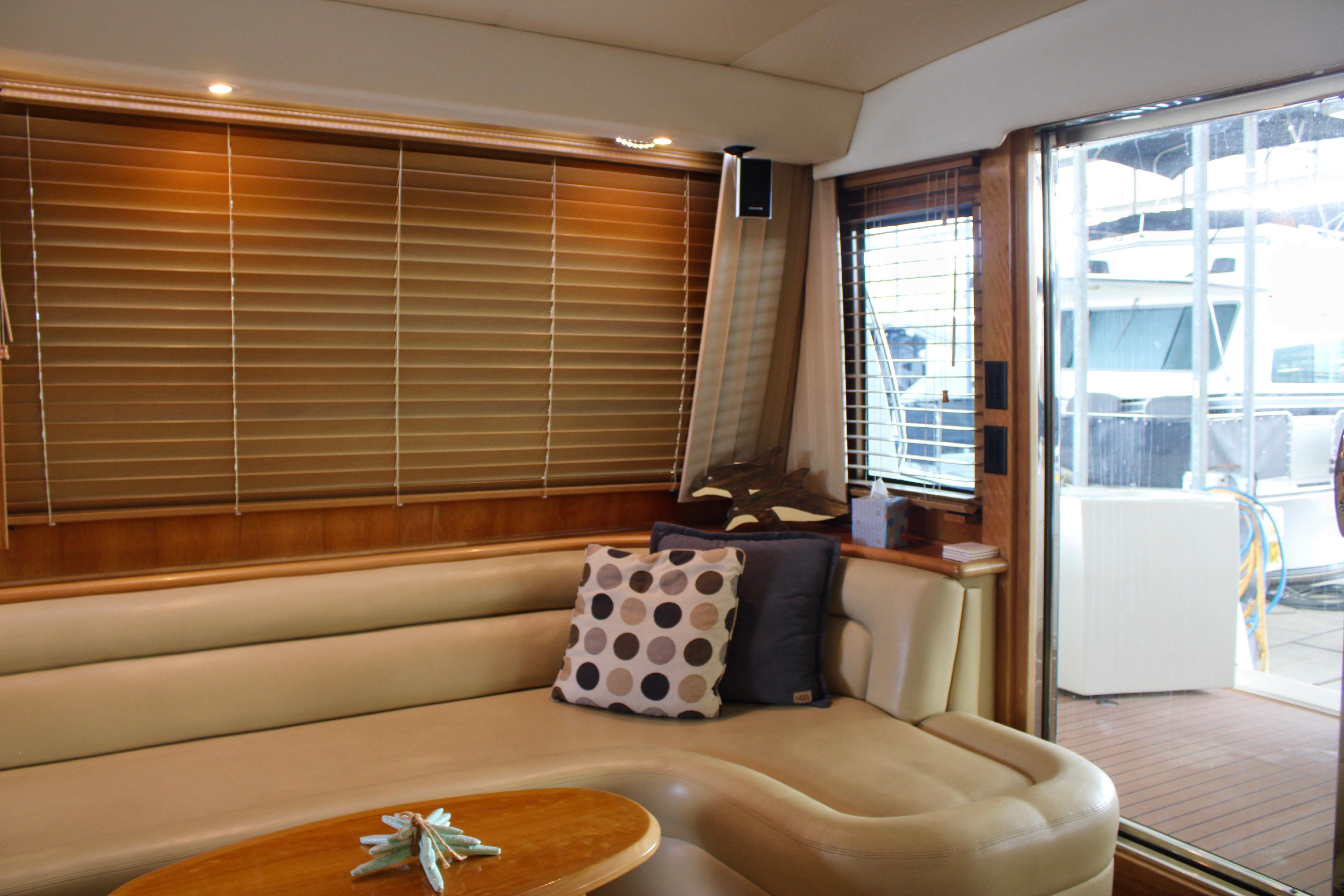 Luxurious interior of 2007 Navigator 5100 yacht with plush seating and elegant decor.