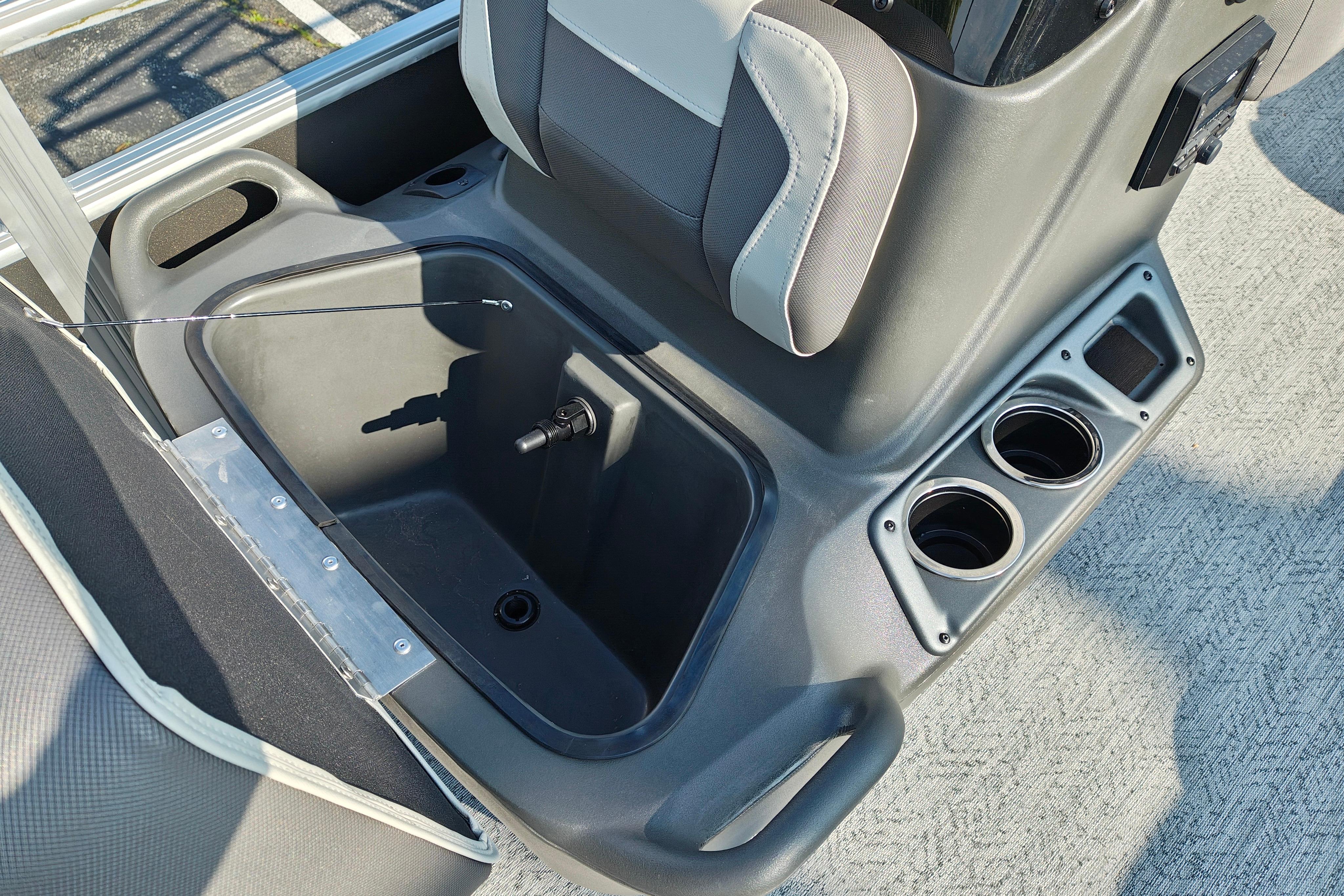 2026 Sun Tracker Bass Buggy 18 DLX interior with storage compartment and cup holders.