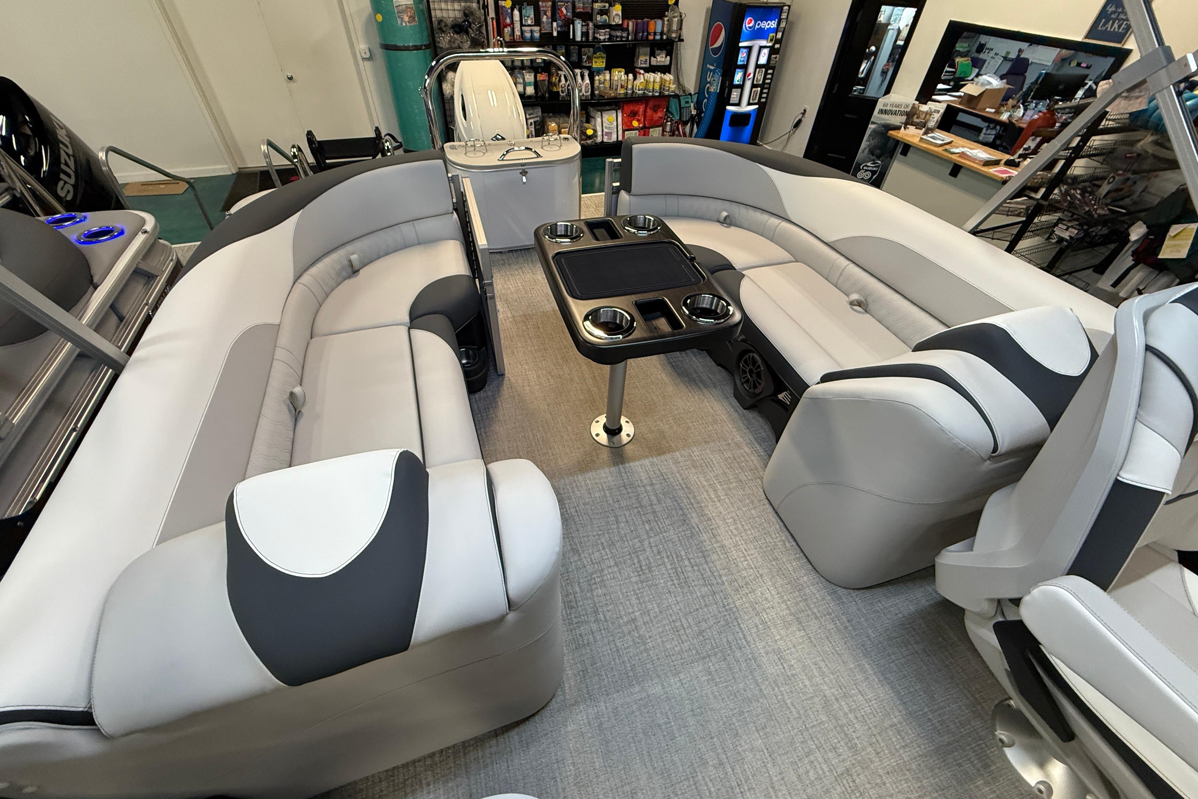 2026 Tahoe Pontoon LTZ Quad Lounger interior with plush seating and central table.