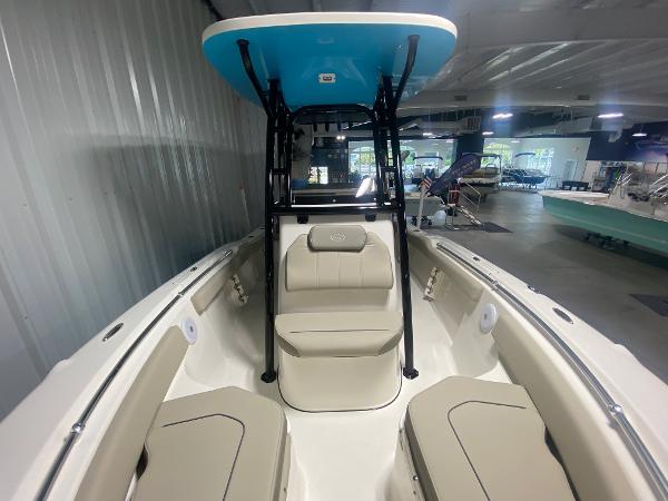 2024 Key West 219 FS boat interior with seating and T-top in showroom.