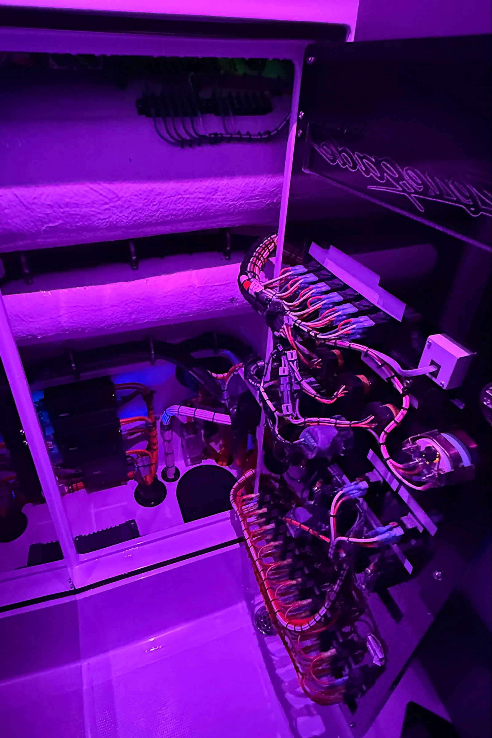 Renegade Open 42 electronics system, 2027 model, illuminated in purple light.