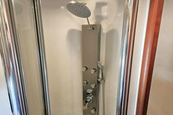 Luxurious shower in 2005 Sunseeker Manhattan 66 yacht, featuring modern fixtures and sleek design.