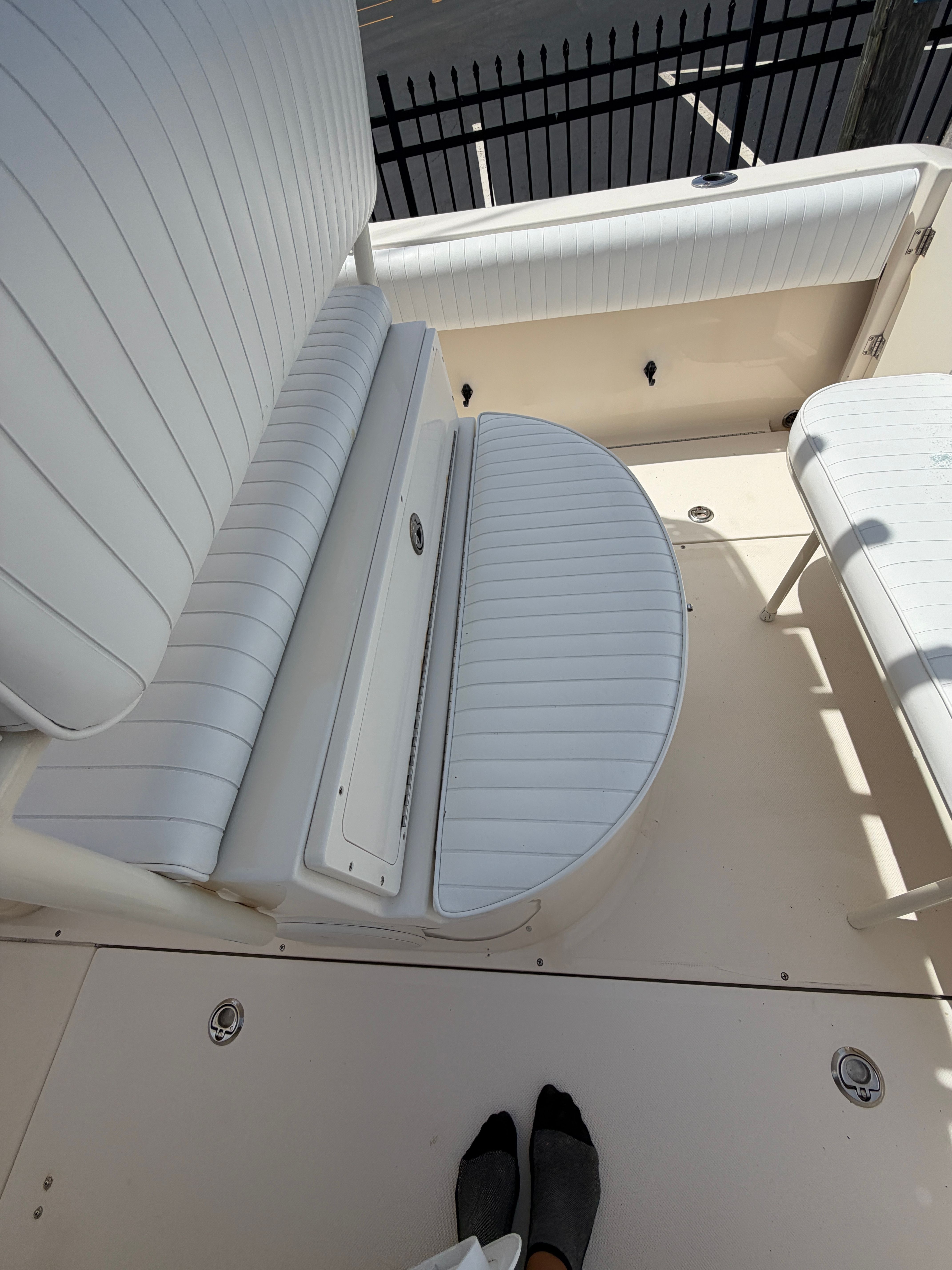 Interior of a 2004 McKee Craft 24 FREEDOM boat with white seating.