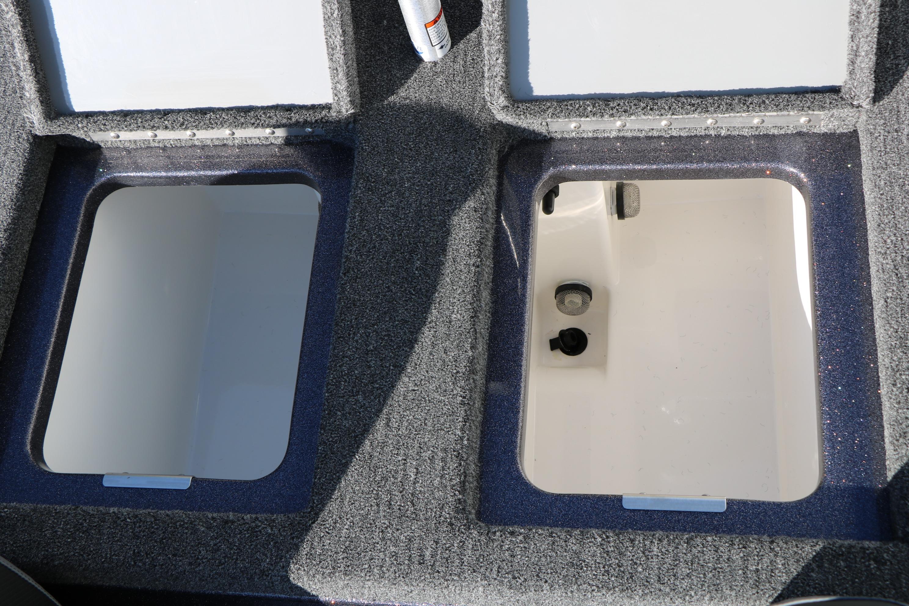 2027 Caymas 201 Pro boat storage compartments with carpeted finish.
