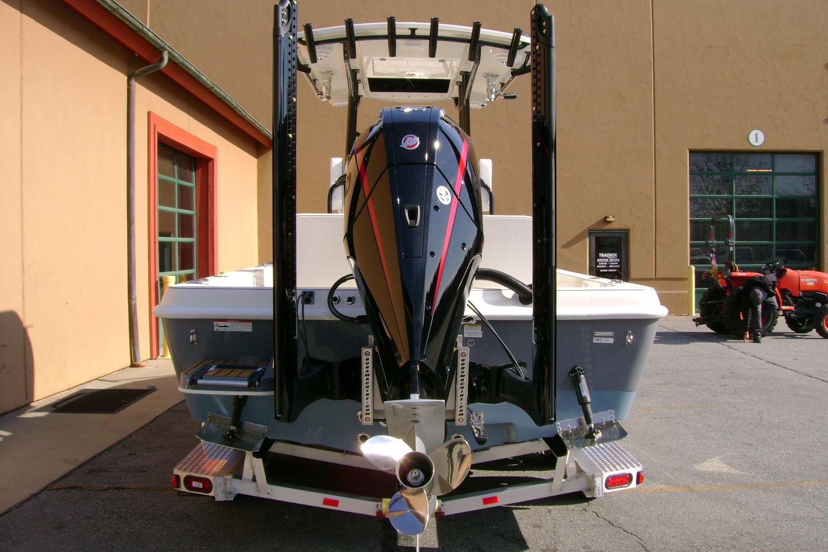 2026 Ranger 2360 Bay boat with powerful outboard motor, parked outdoors.