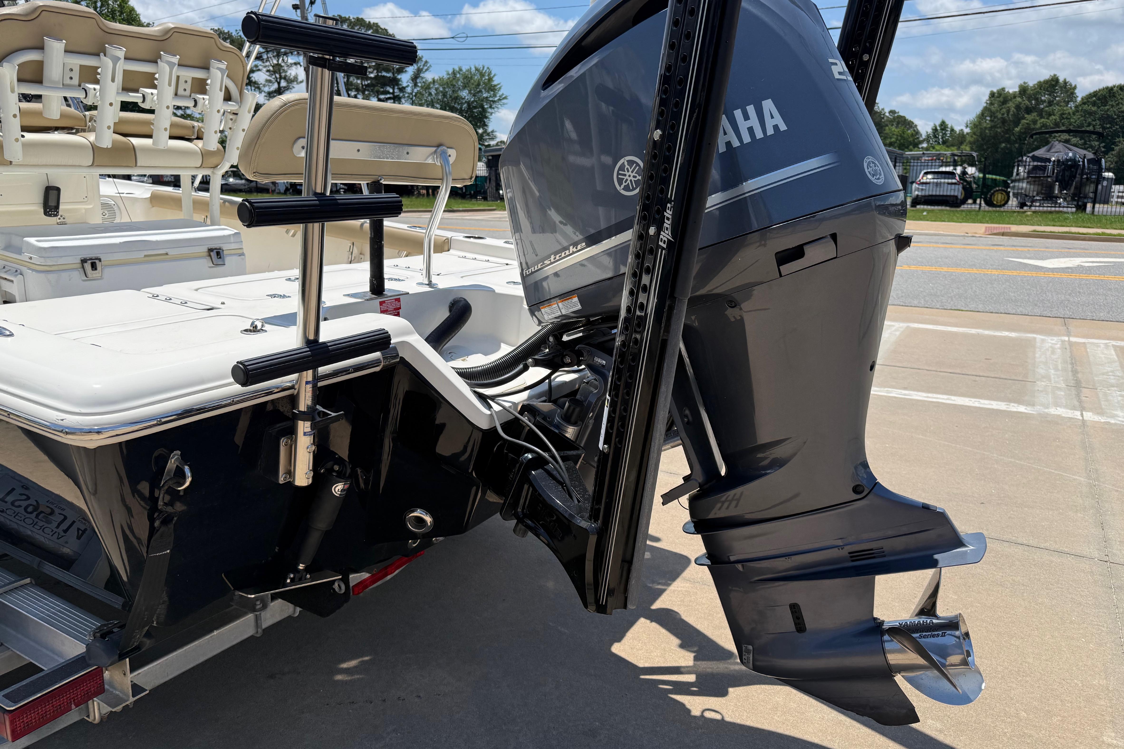 2019 Key West 230 Bay Reef boat with Yamaha outboard motor, docked on pavement.