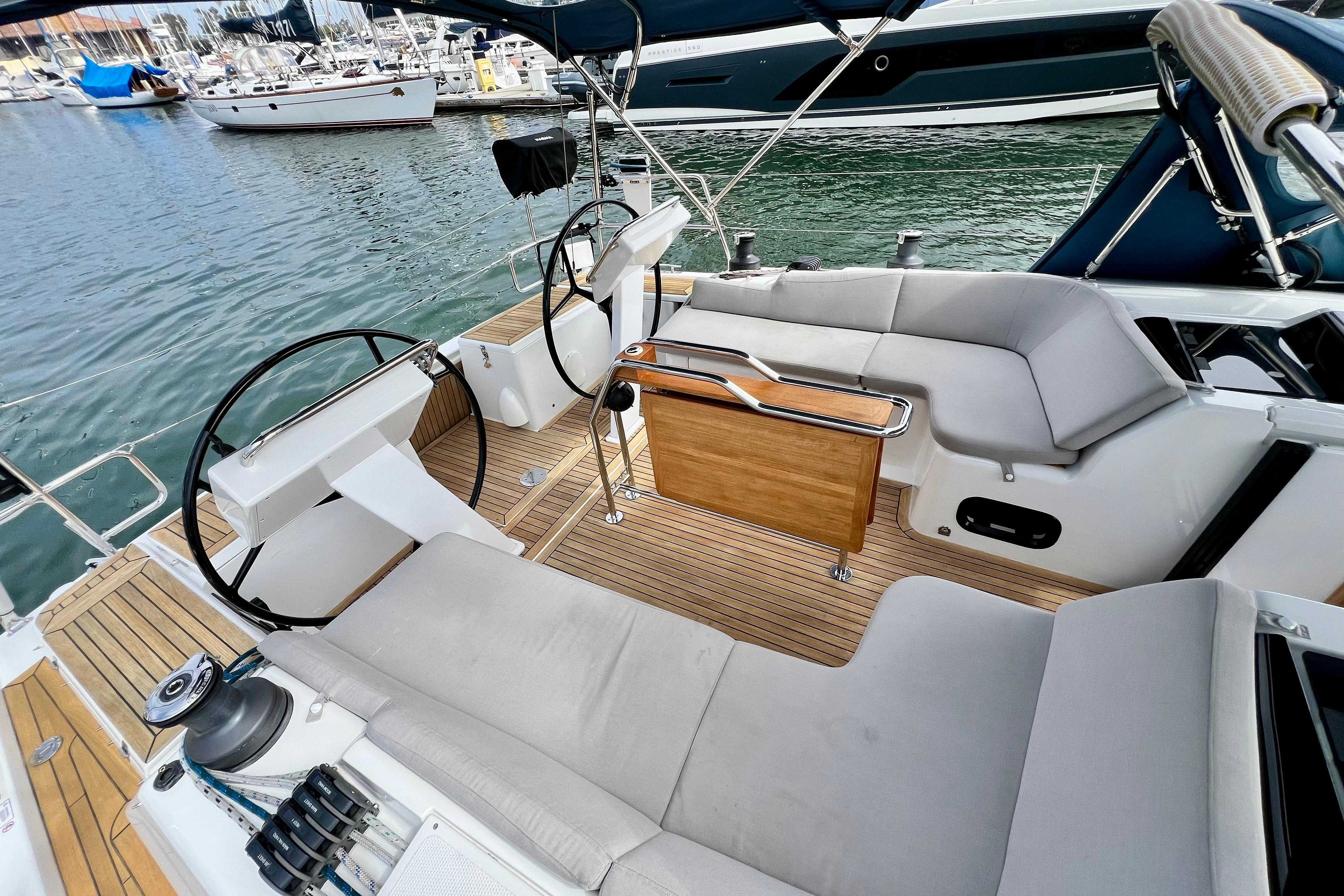 Spacious cockpit of 2016 Hanse 455 yacht with dual steering wheels and comfortable seating.